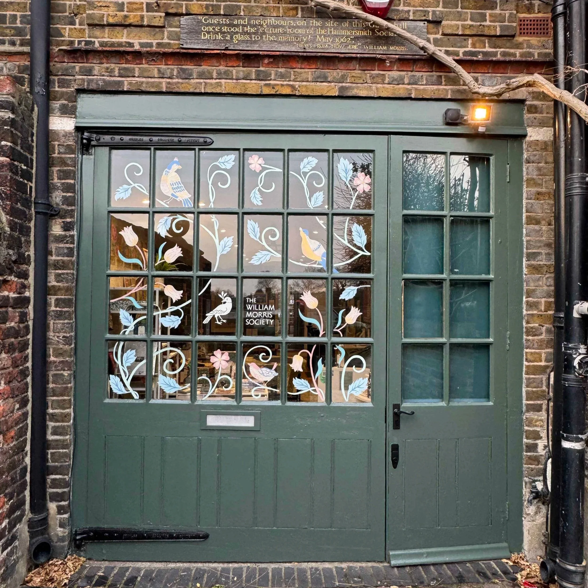 Completed window mural design hand-painted across the museum carriage doors