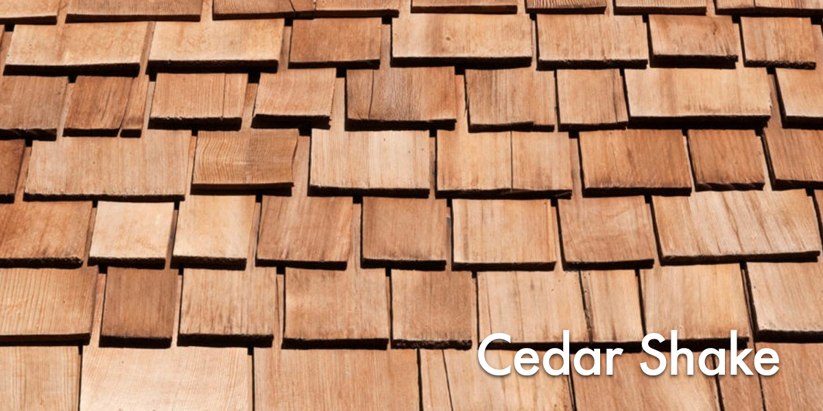 Close-up of overlapping cedar shake wooden shingles on a roof.