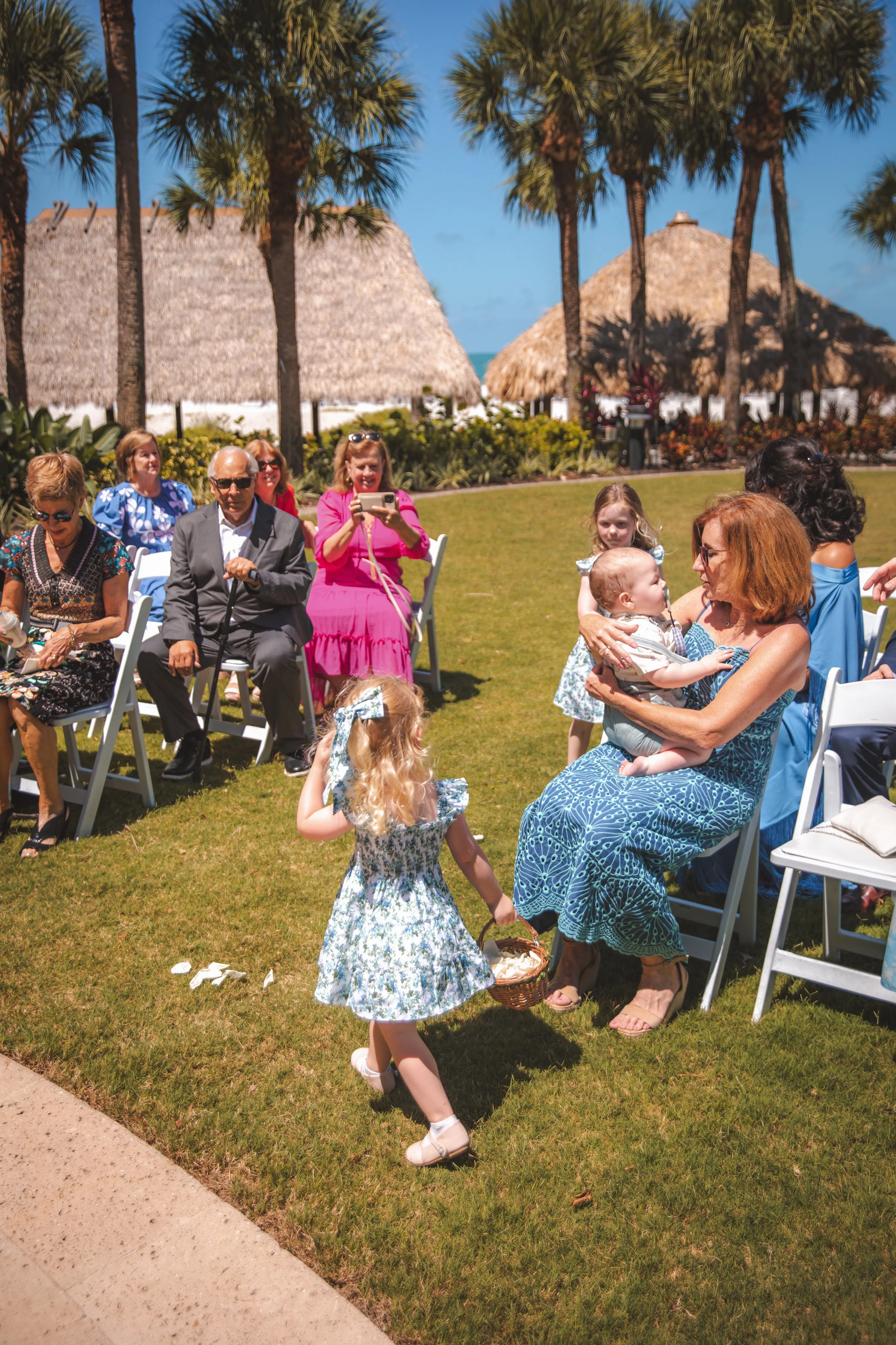     Flower girl walking down the aisle at the Ritz-Carlton Beach Club Sarasota