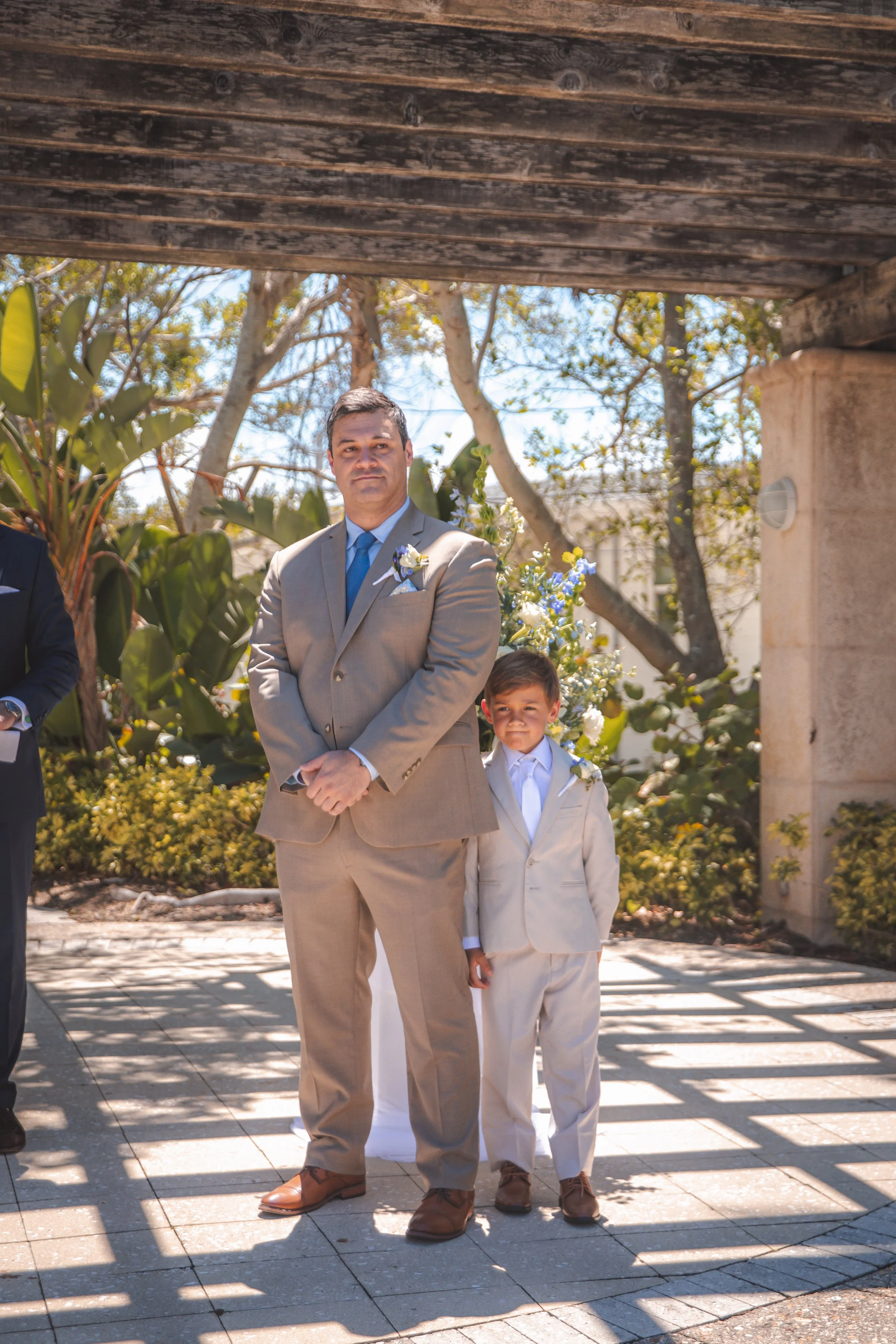     Groom standing with the ring bearer before the ceremony at the Ritz-Carlton Beach Club