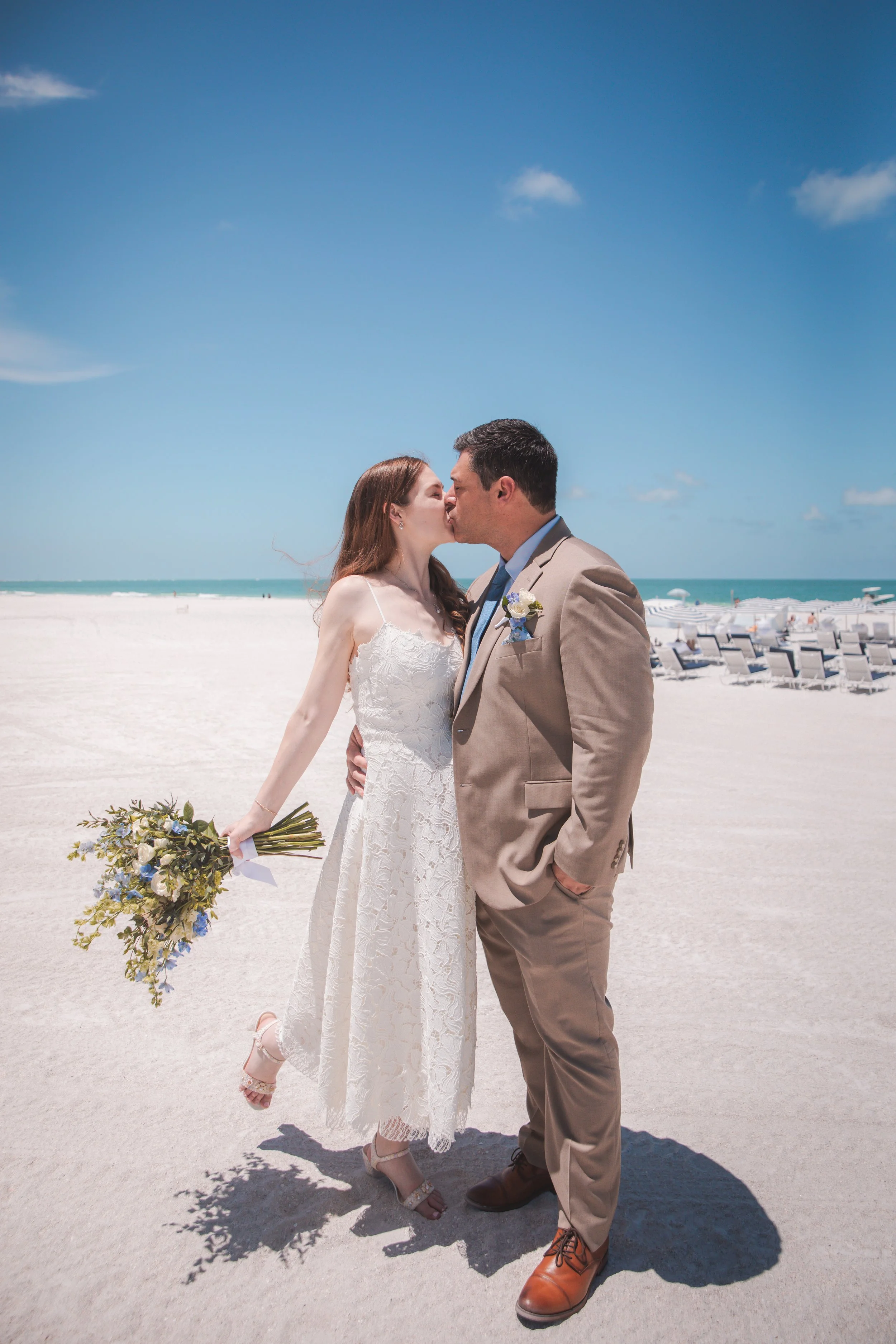 Newlyweds kissing on the beach after their Ritz-Carlton Sarasota wedding