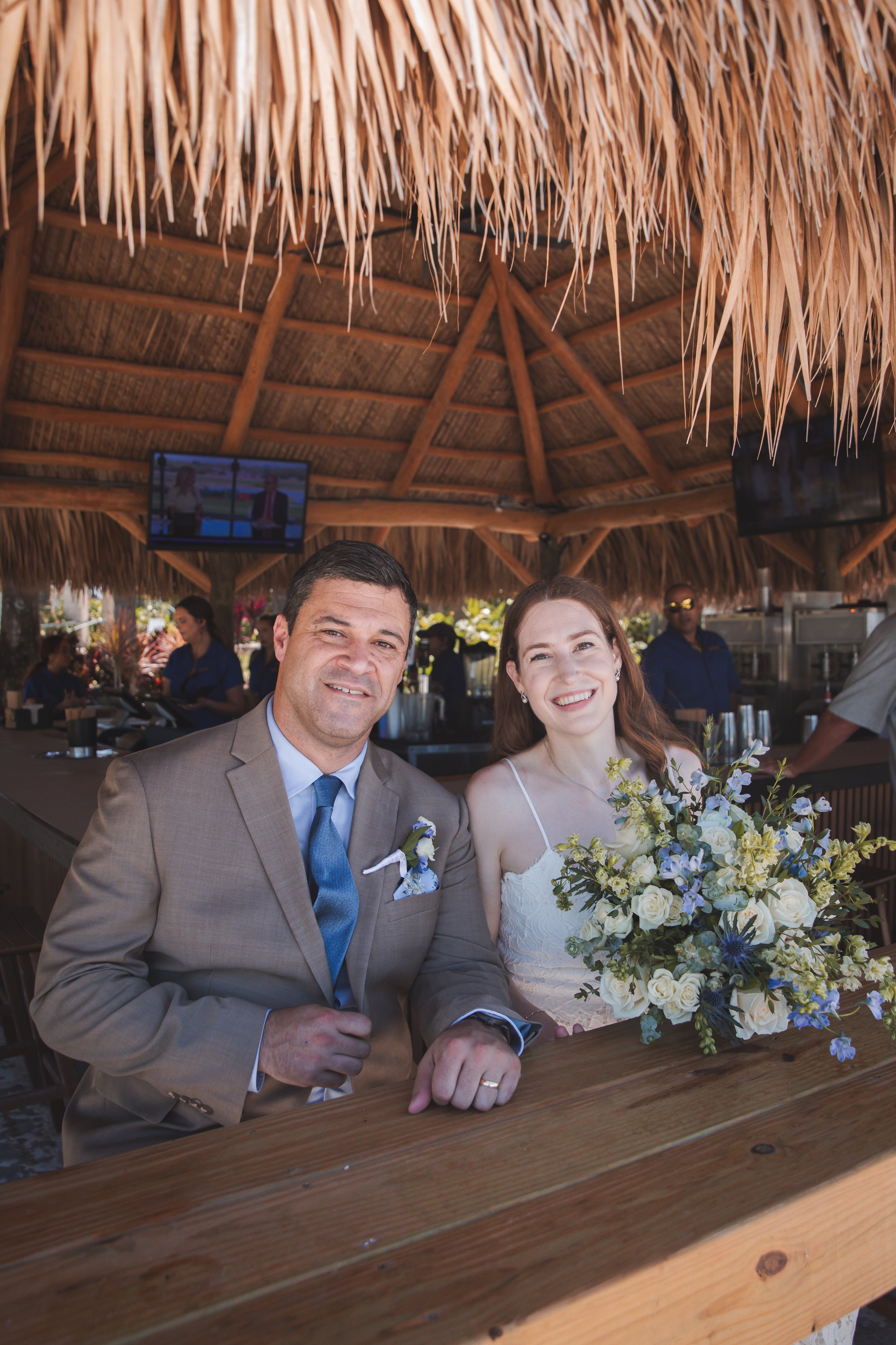 Bride and groom seated together during their wedding luncheon at the Ritz-Carlton Beach Club