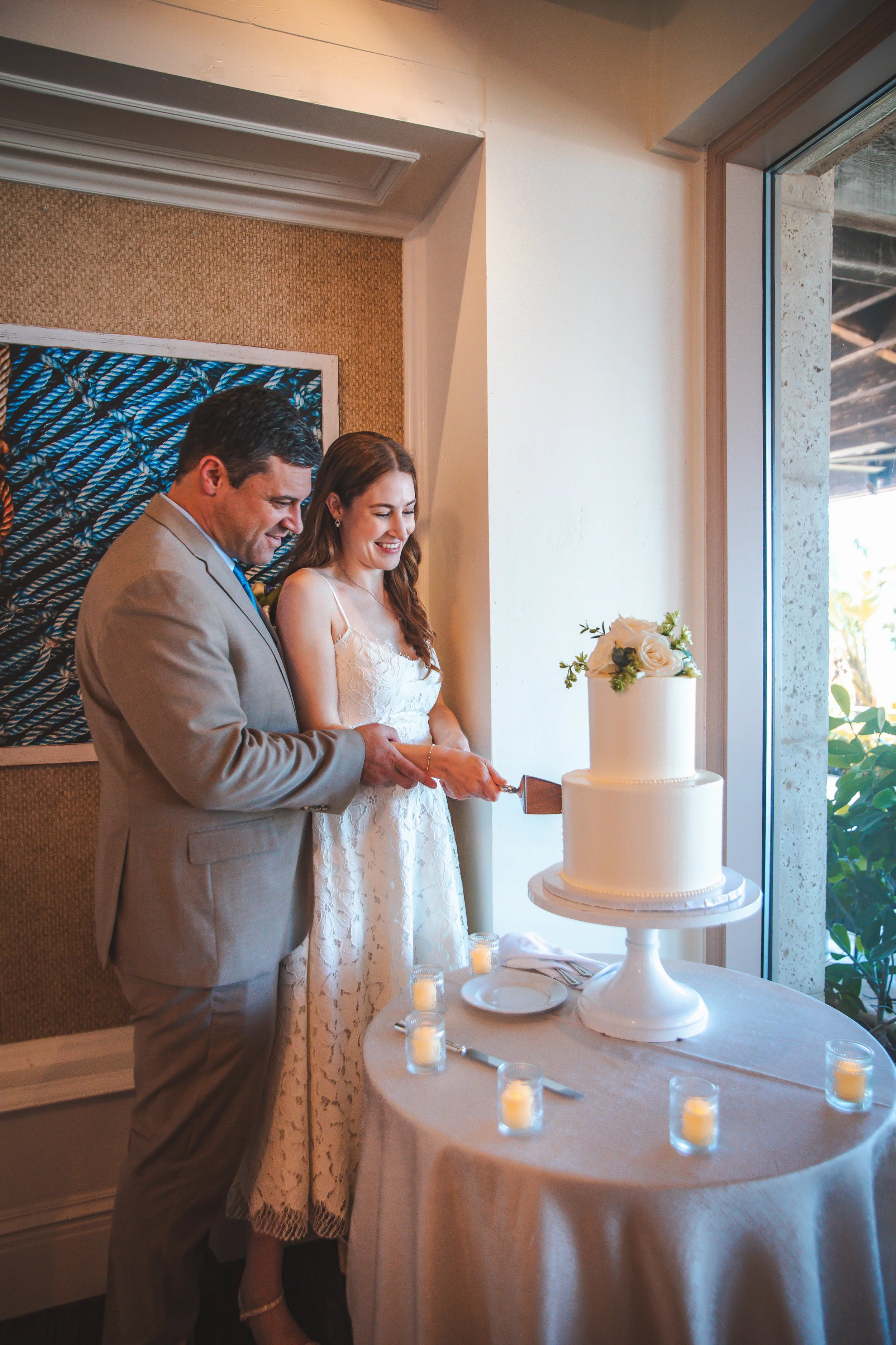 Bride and groom cutting their wedding cake at the Ritz-Carlton Beach Club Sarasota