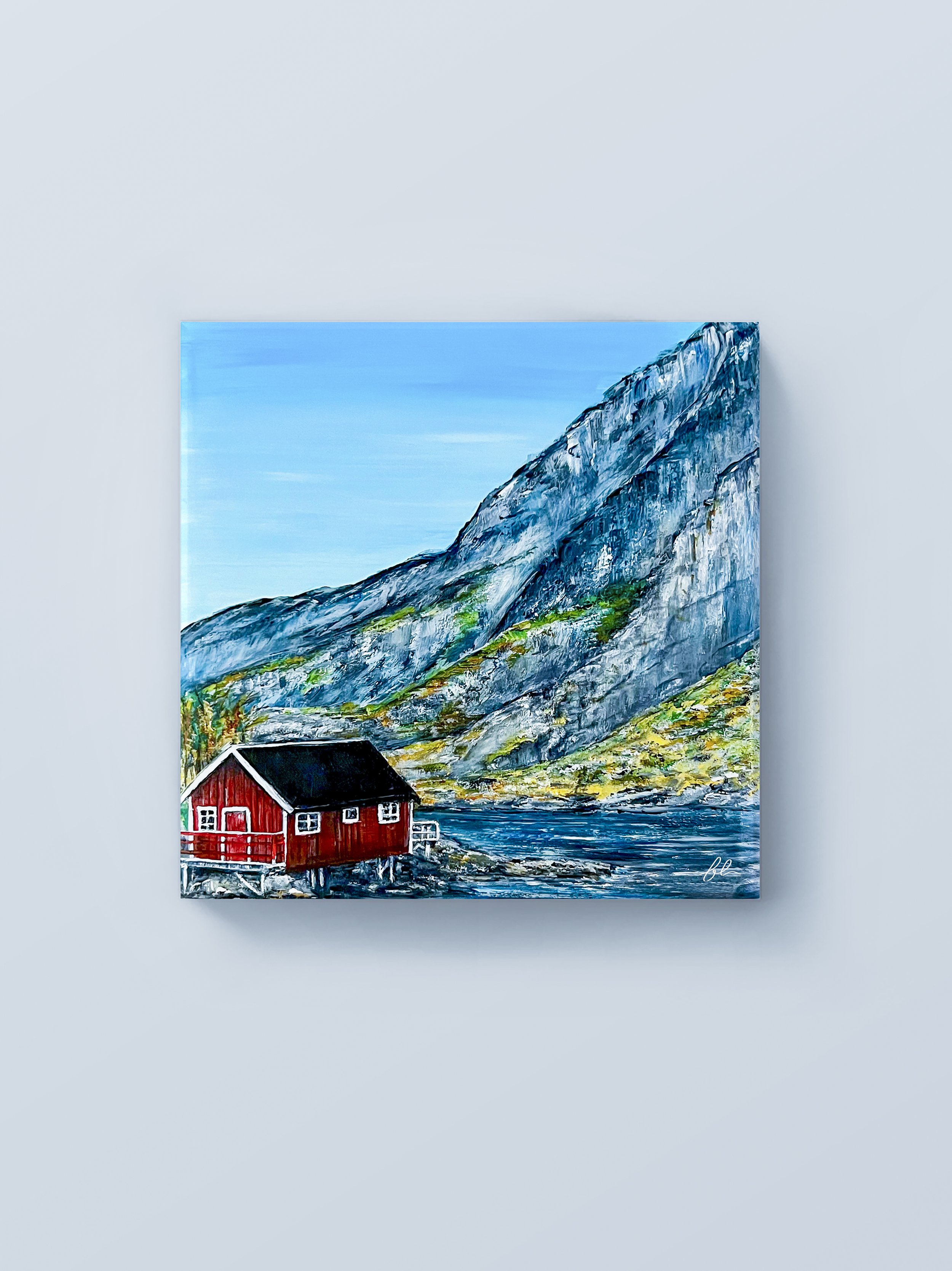 Nestled along the rugged shoreline of Lofoten Islands, a small red rorbu cabin rests quietly beneath towering coastal mountains. “Where The Mountain Meets The Tide” captures the dramatic beauty of Norway’s northern landscape, where steep cliffs, deep