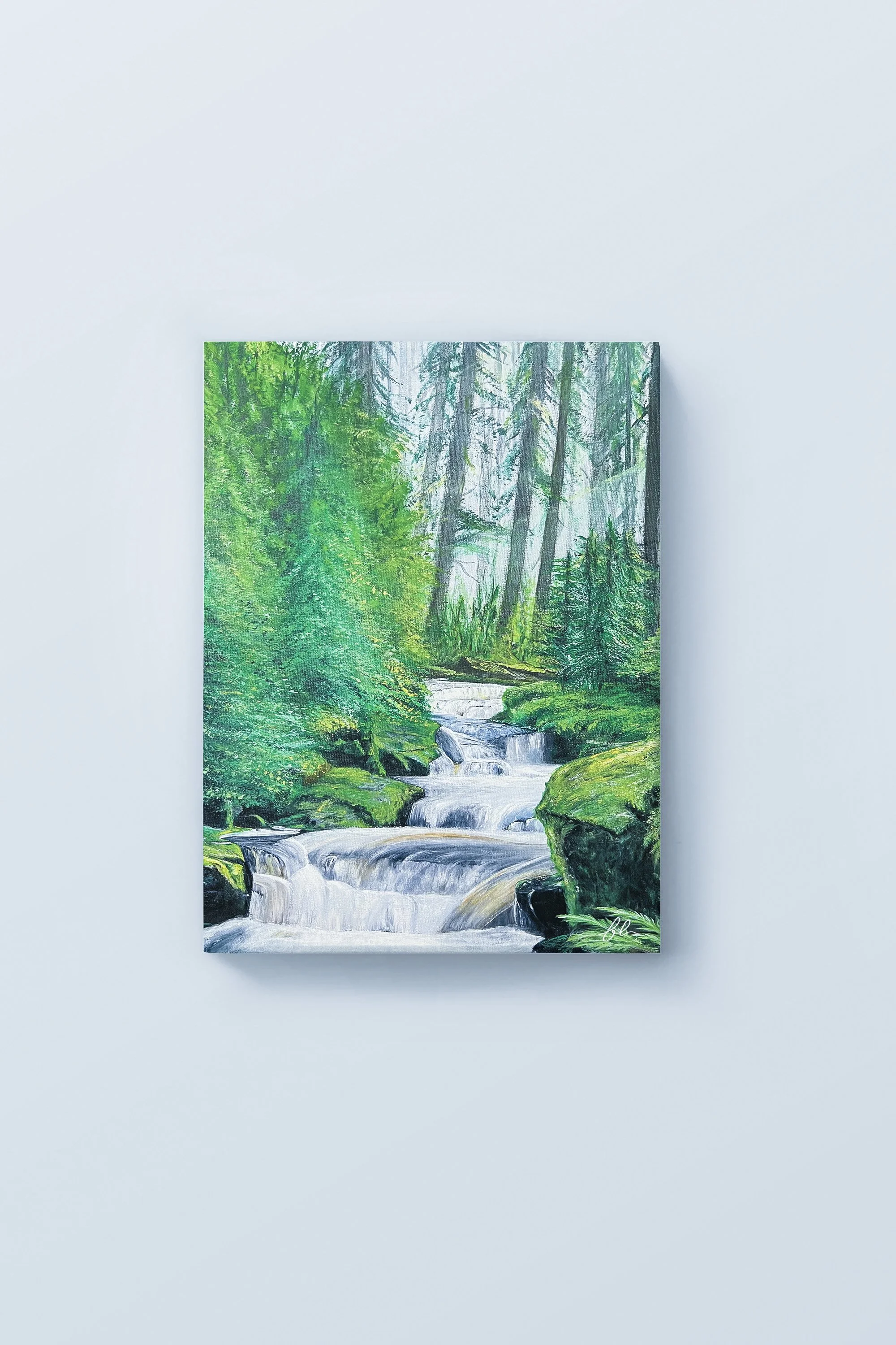 A gentle cascade winds its way through lush forest greenery in “Veil of the Woods.” Inspired by the tranquil beauty of Great Smoky Mountains National Park, the painting captures filtered light, moss-covered stones, and the quiet movement of water hid