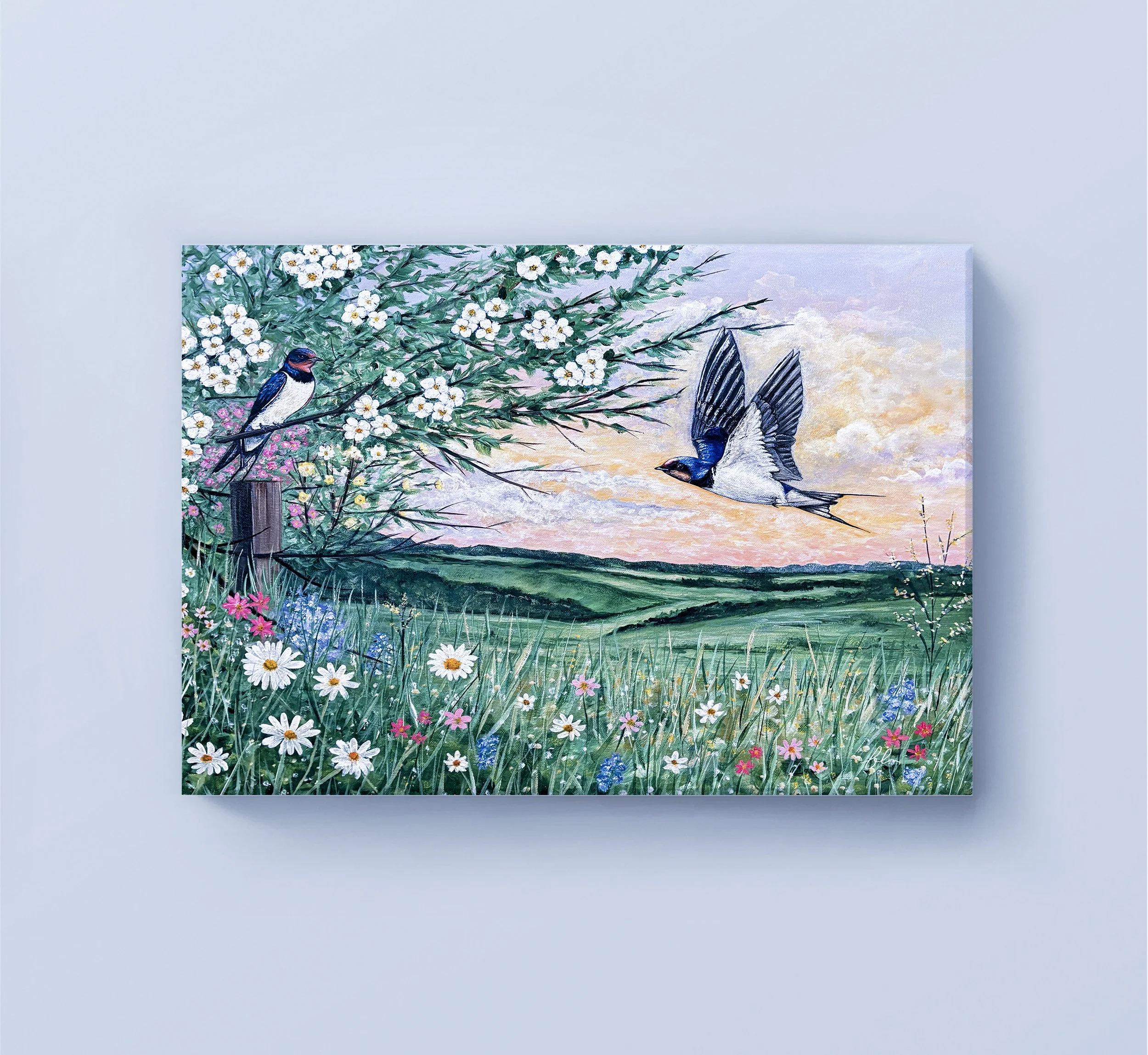 Where the Swallows Return celebrates the beauty of spring as two barn swallows soar above a blooming countryside. Surrounded by wildflowers, flowering branches, and rolling green hills, this original acrylic painting captures the peaceful renewal of 