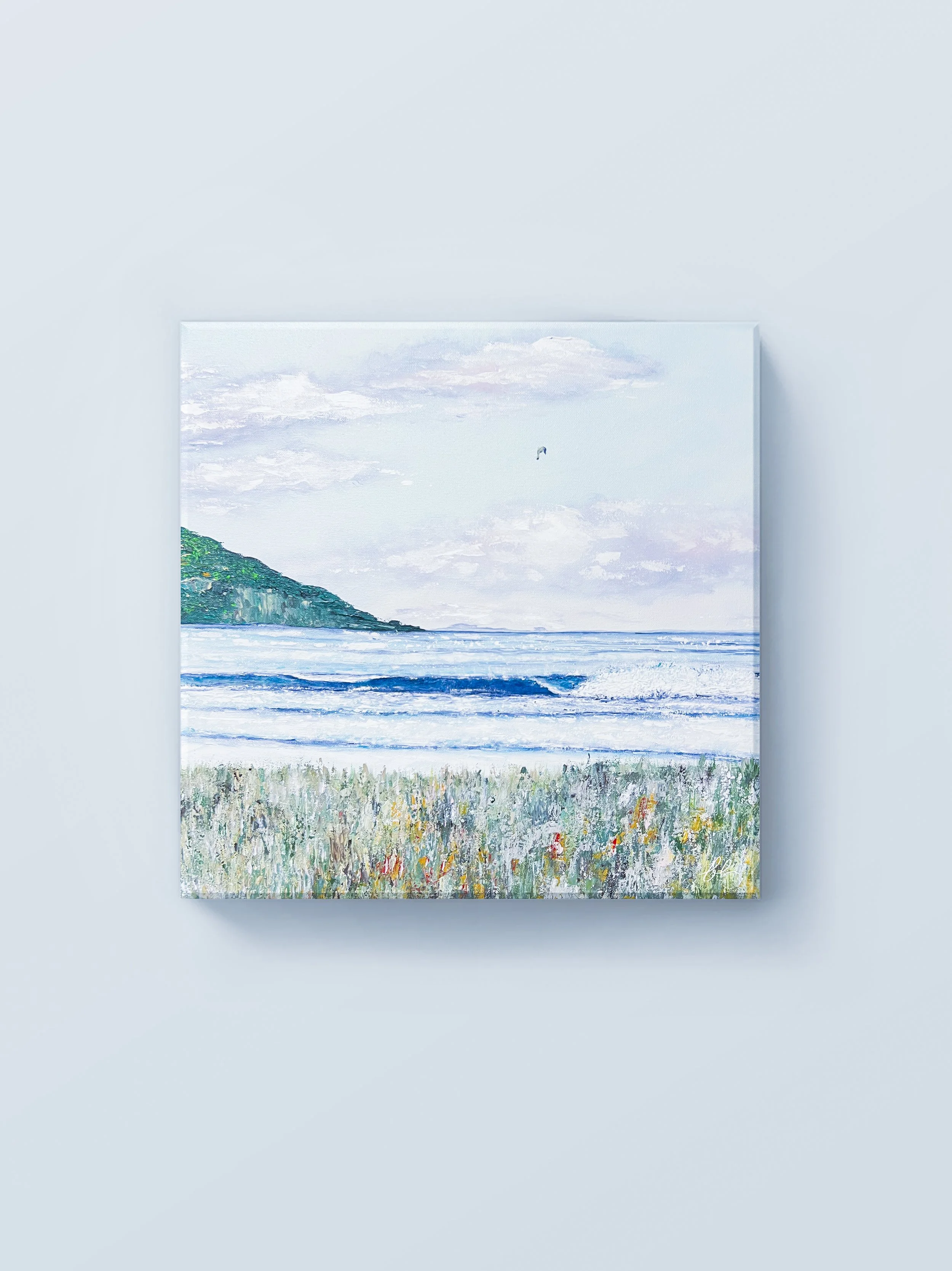 Gentle waves roll toward a quiet shoreline beneath an open sky in “Soft Horizons.” Inspired by the coastal beauty of Prince Edward Island, the painting captures the peaceful rhythm of the sea, where distant cliffs, soft clouds, and wild coastal grass