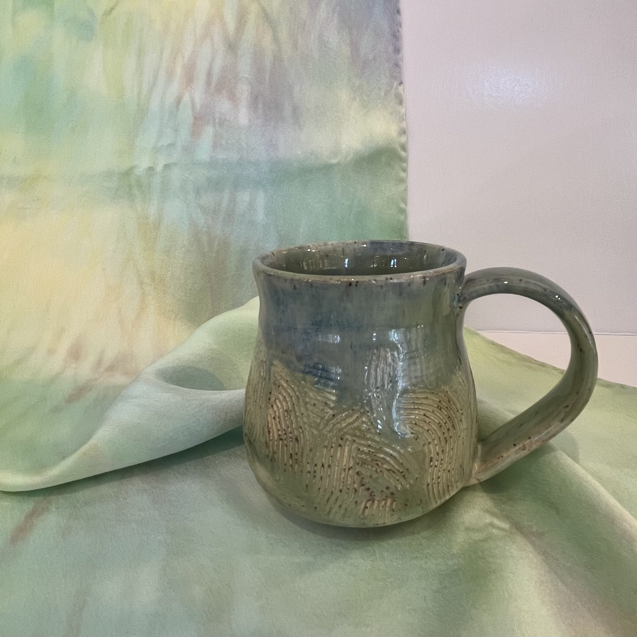 Pottery by our new summer helper, Vivian, who is a sophomore at Tufs University studying Fine Arts. The locely scarf in the background is Hand dyed silk charmeuse by local artisan Judi Eichler.