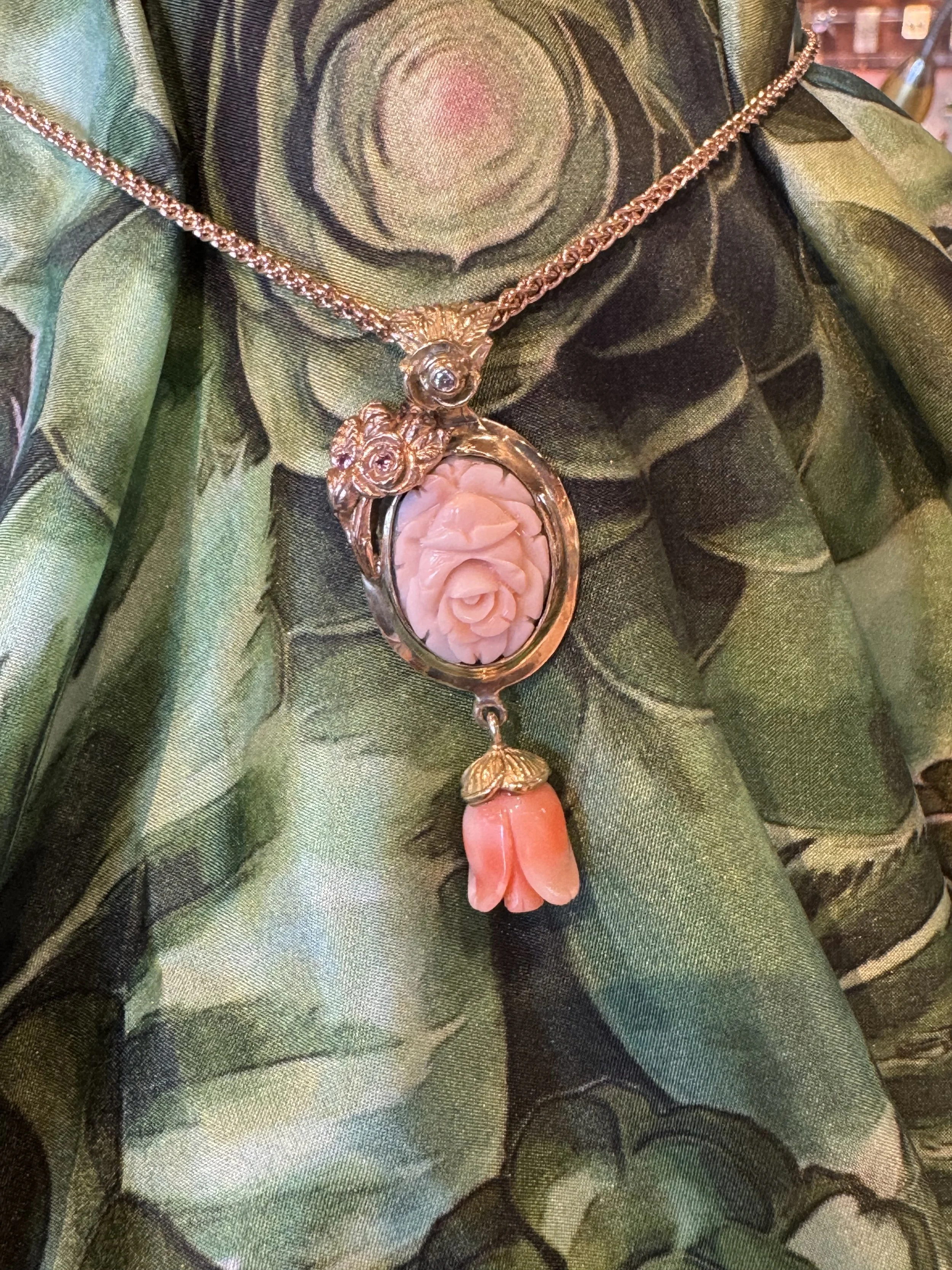 Come check out this beautiful 14k Gold with legally harvested Angel Skin Coral, necklace by Bruce Tapley! It is showcased on a silk scarf by Ms Dumont. He is a new Artisan to Shady Lane who creates his jewelry from his home in Maui. He takes inspirat