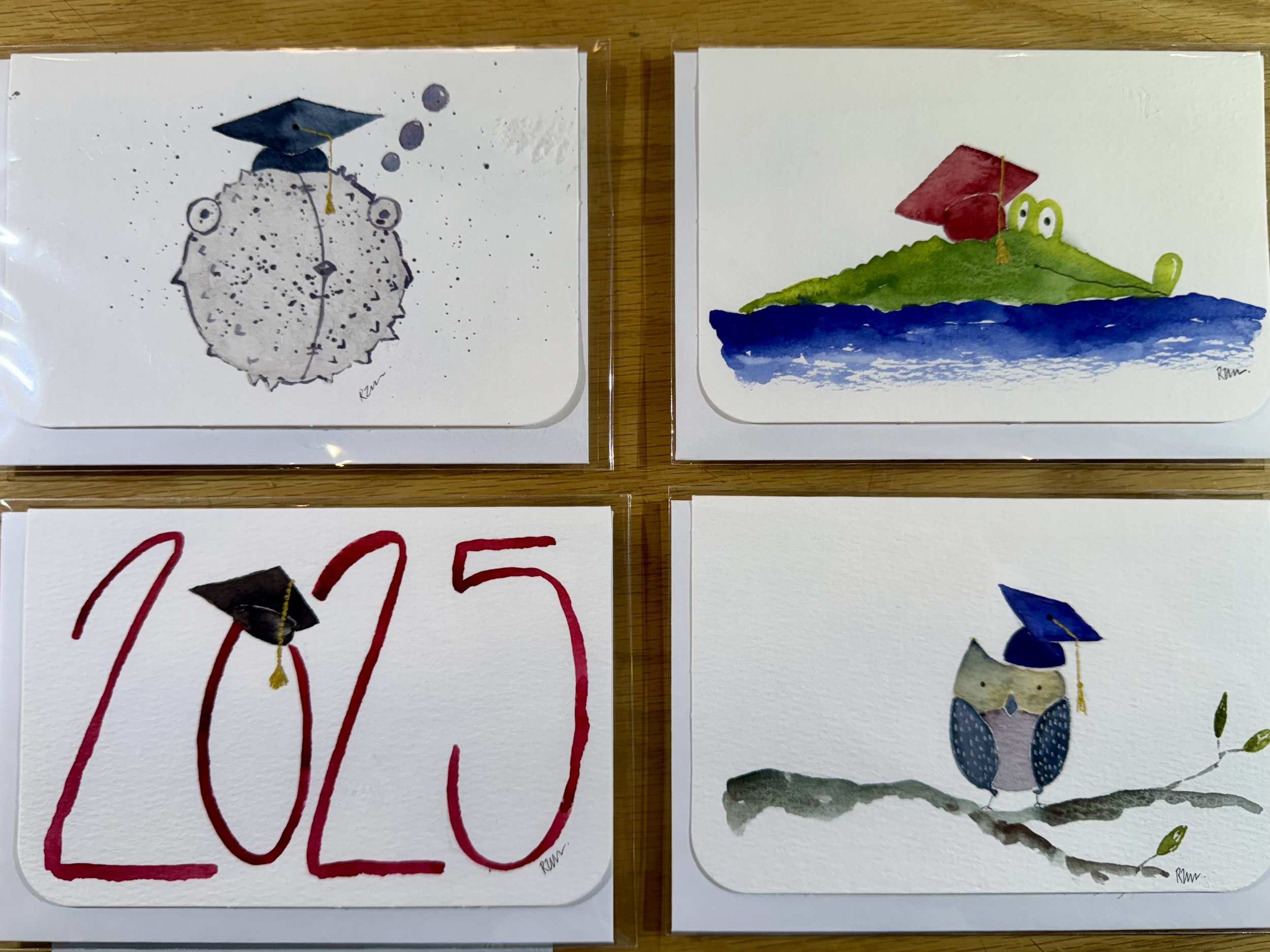 Hand painted and signed graduation cards by local artisan Robbie Mellows. each one an original! We are selling them by the handful The perfect card to give to that unique one of a kind graduate in your life!