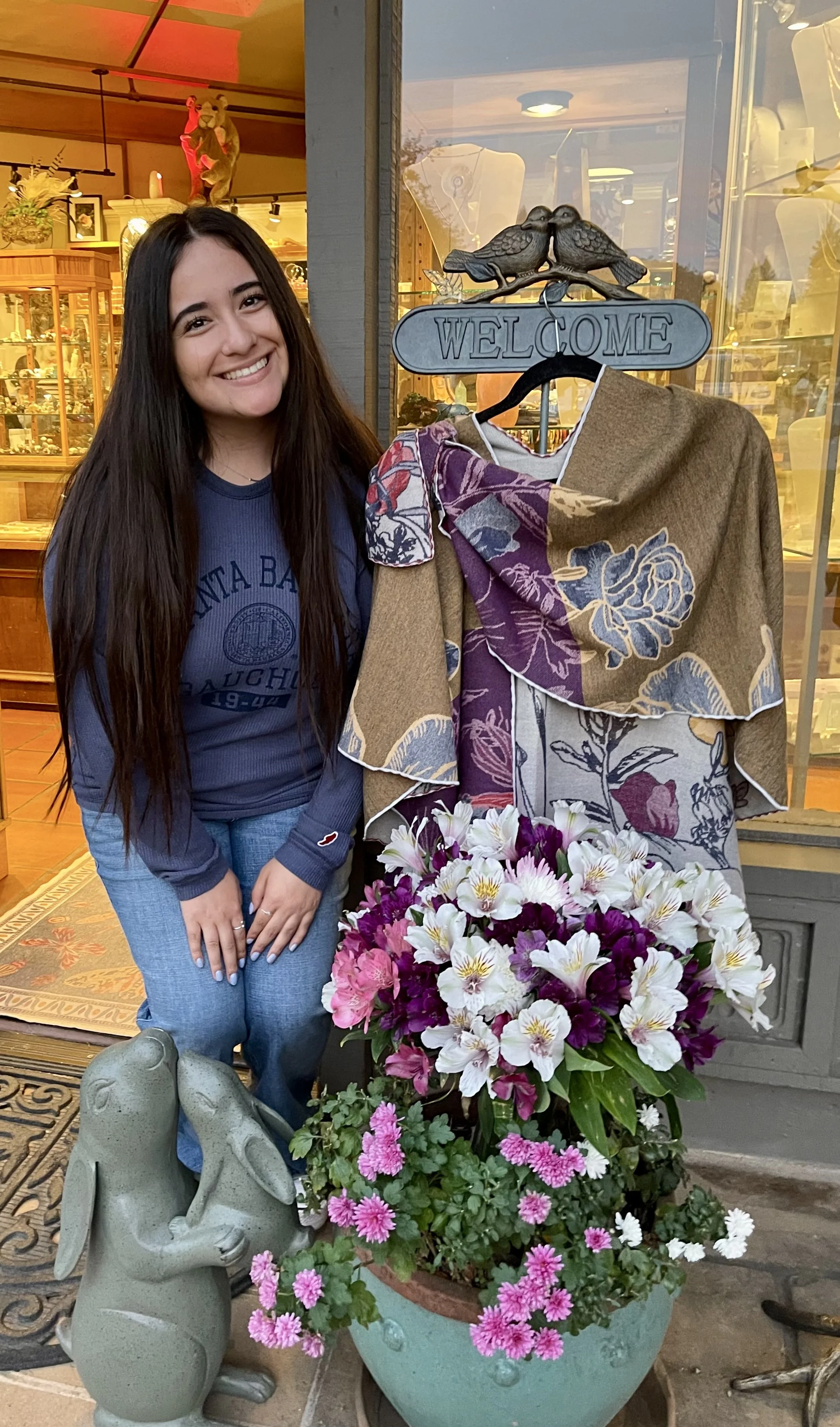 We welcome MaryCarla to Shady Lane, posing with our best-selling loop shoulder reversablewrap and flowers arranged by one of our local artisans, Maria Torrey!