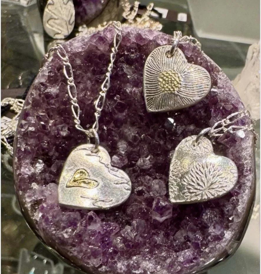 Just in time for Valentine's Day shopping new beautiful gold and silver heart necklaces by local artisan Judi Eichler! Displayed on new specimen amethyst that just arrived today.