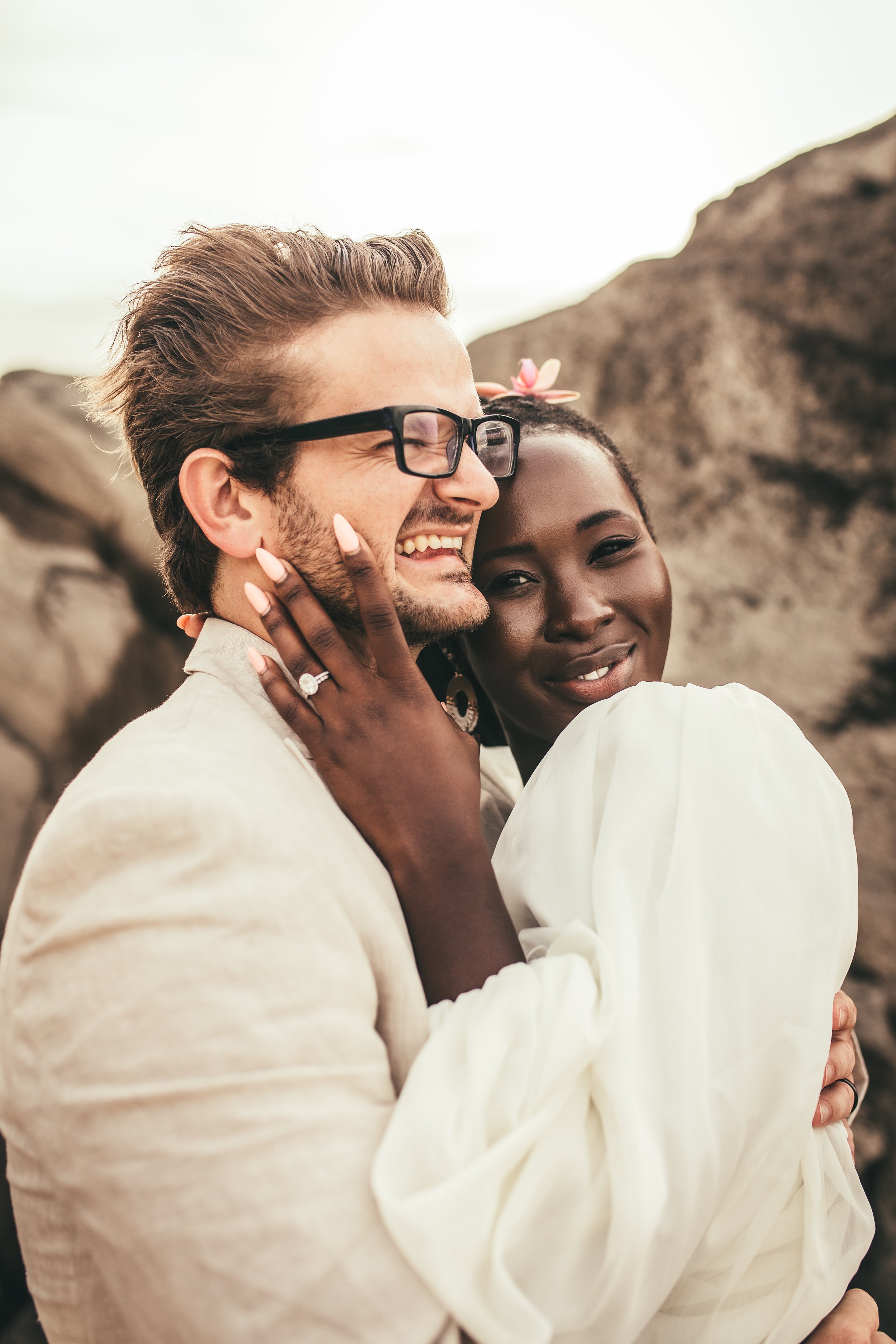 african amercian woman embracing white man on beach at ironwoods beach in kapalua maui