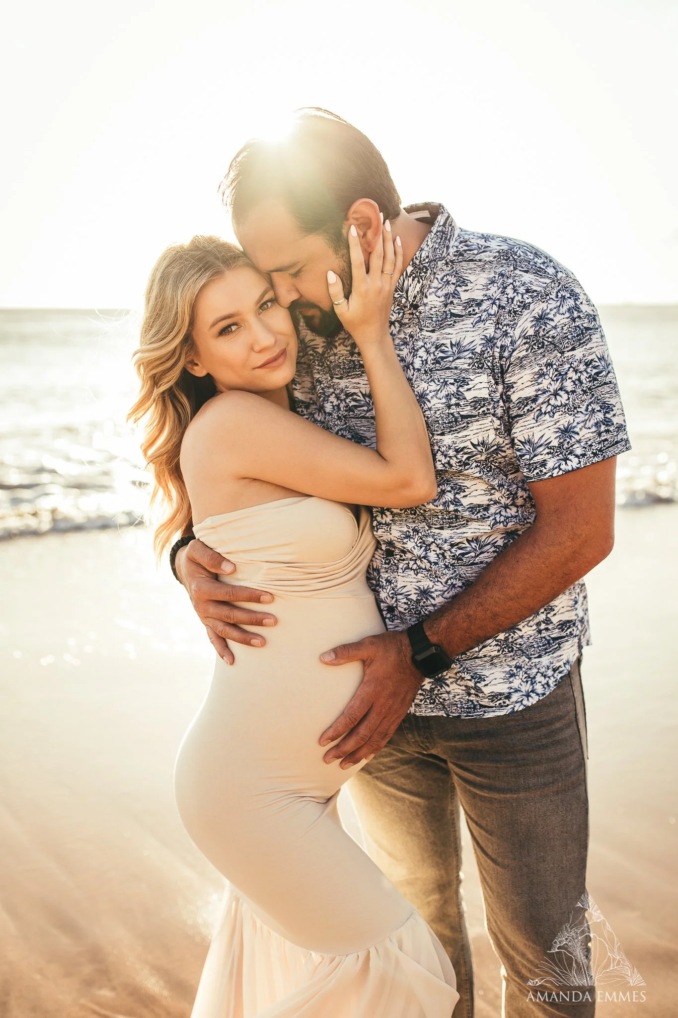man embracing pregnant woman during sunset for a maternity photography session in maui, hawaii
