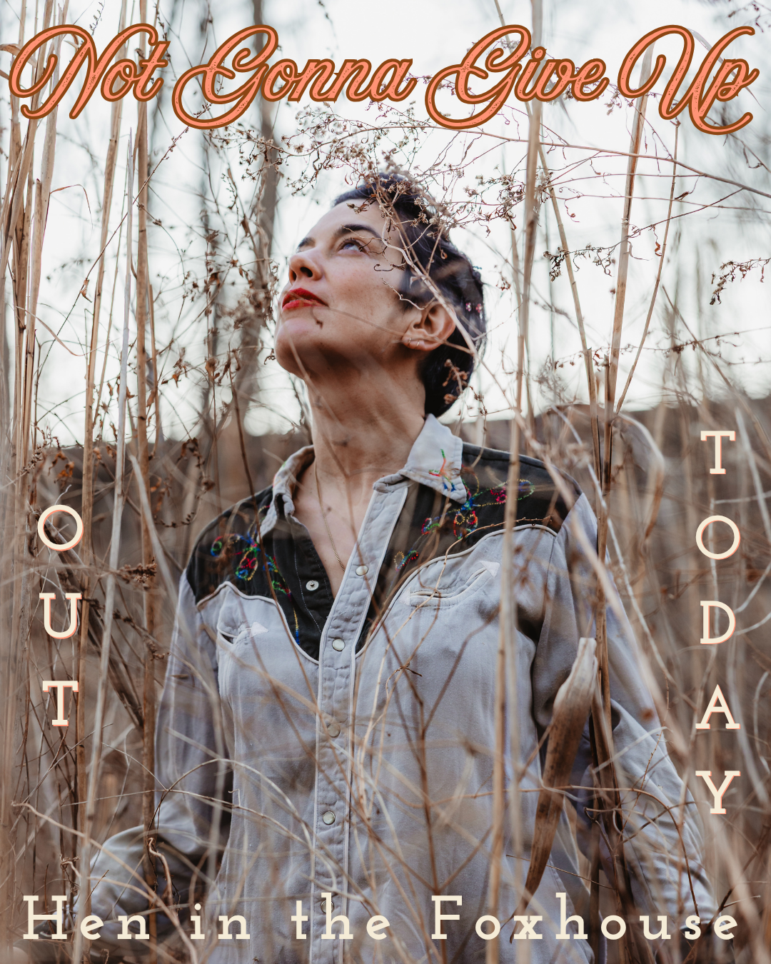 A woman standing in dry, tall grass with a calm expression, looking upwards. Text overlays read 'Not Gonna Give Up', 'OUT', 'TODAY', and 'Hen in the Foxhouse'.
