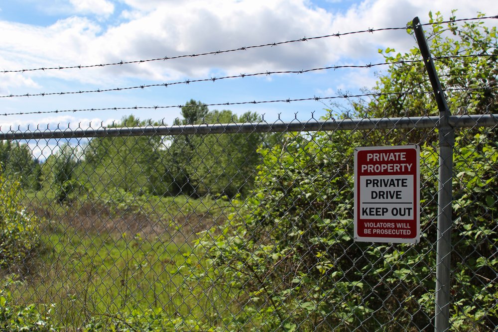  A private property sign posted on a barbed wire fence to keep people out of the contaminated terminals. // Trinity Shaffer 