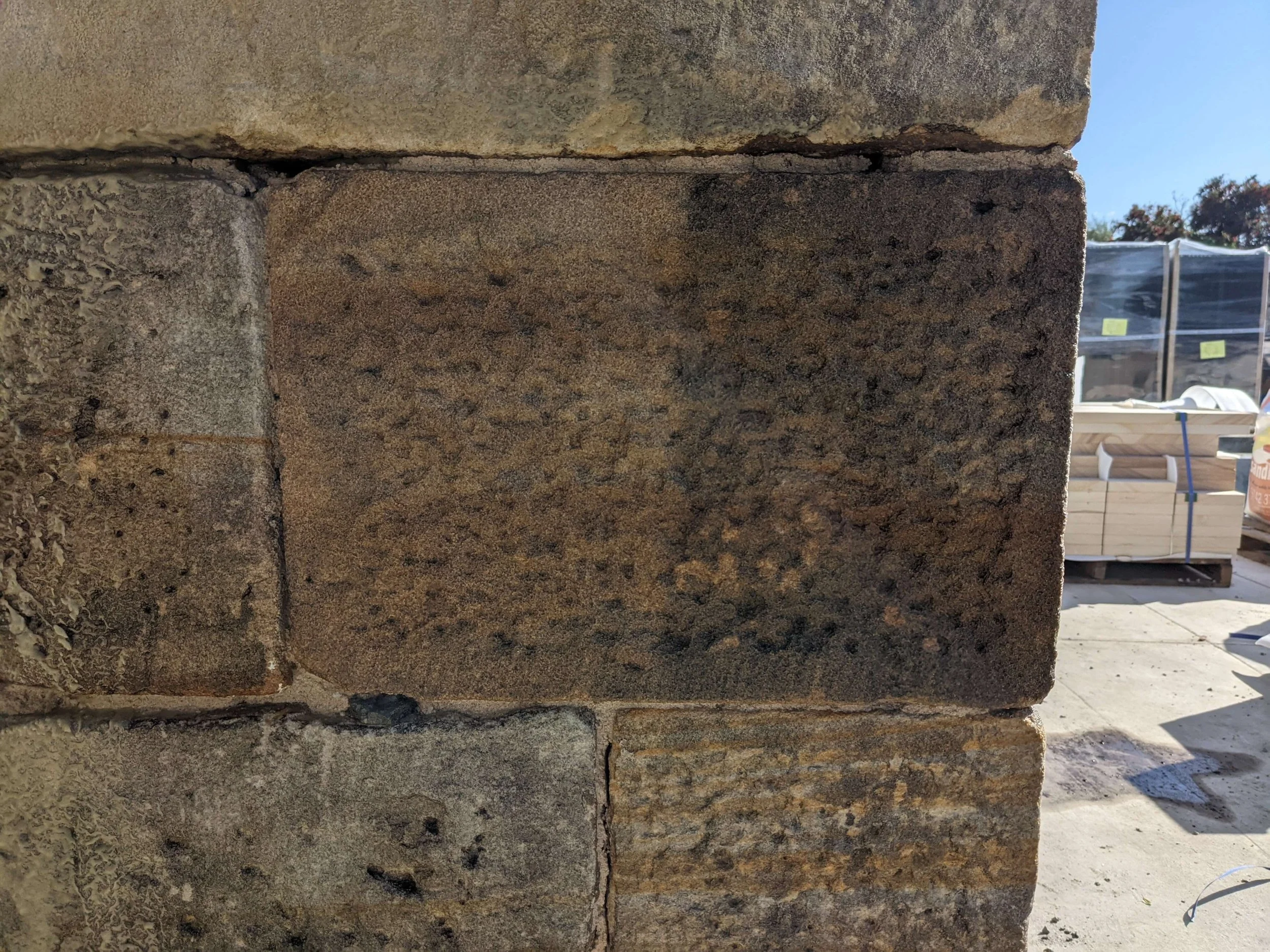 side by side comparison of cleaned versus uncleaned fire damaged stone at macarthur house using the jos system photo 1 of 3