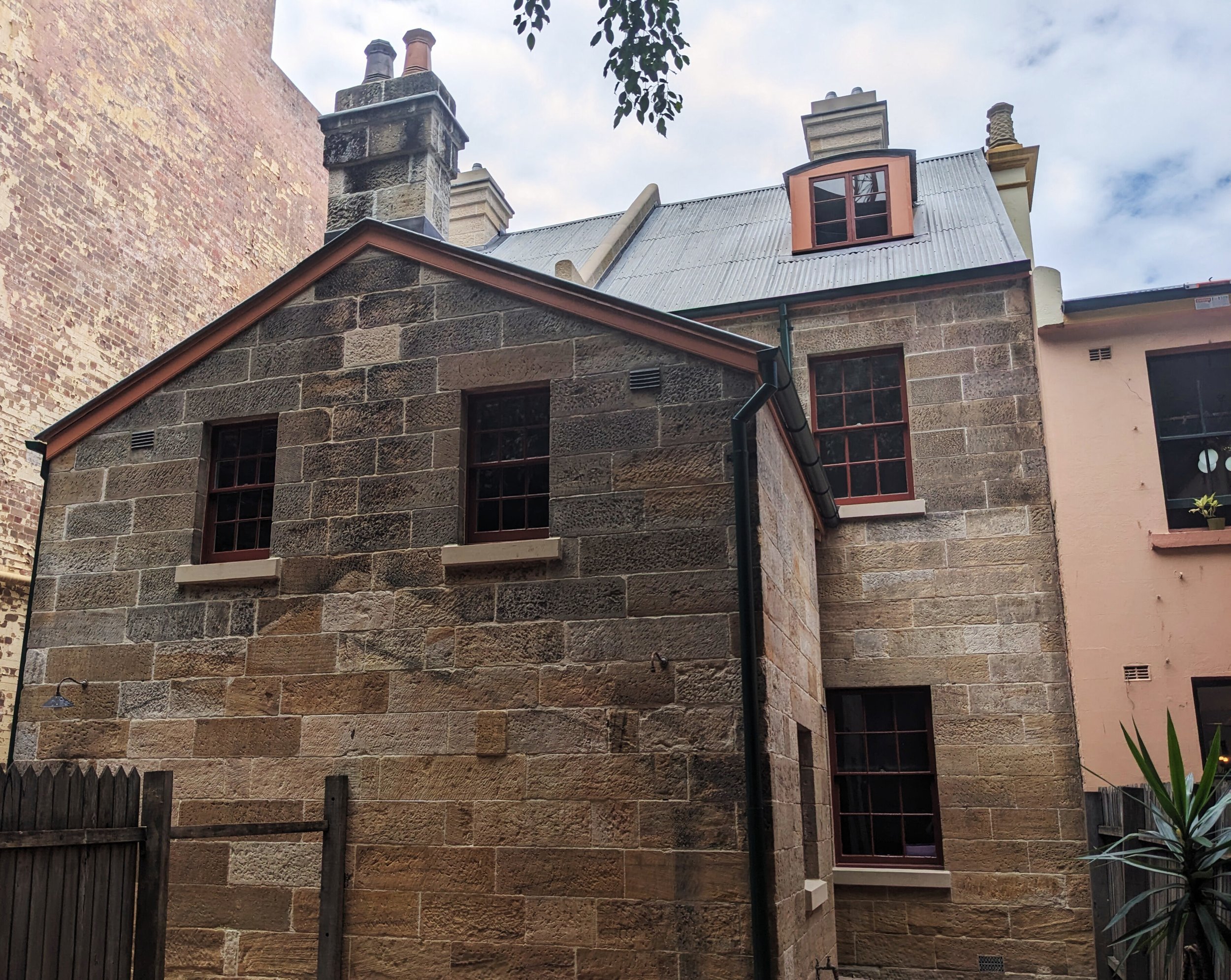 a photo of a paint stripped historic terrace at 29-31 George Street The Rocks showing the orgininal stonework after the paint was removed.
