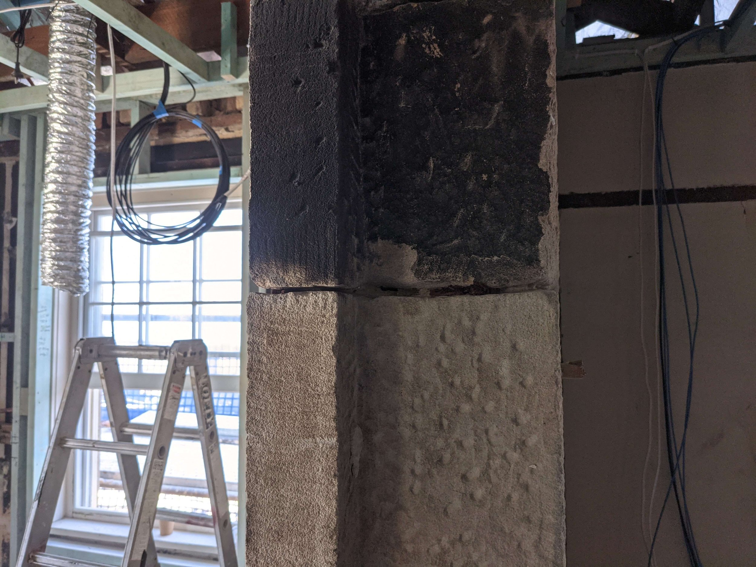 side by side comparison of cleaned versus uncleaned fire damaged stone at macarthur house using the jos system photo 3 of 3