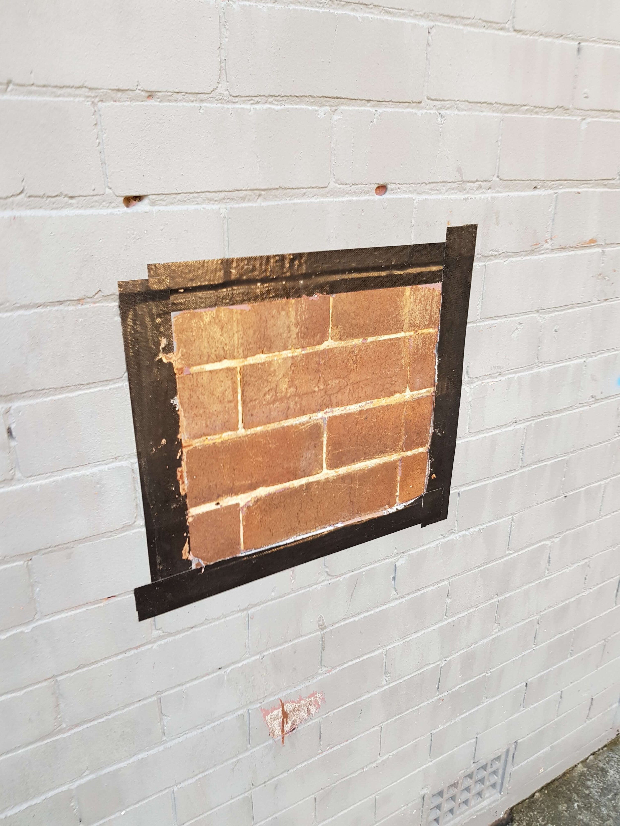 white paint removed from brick wall