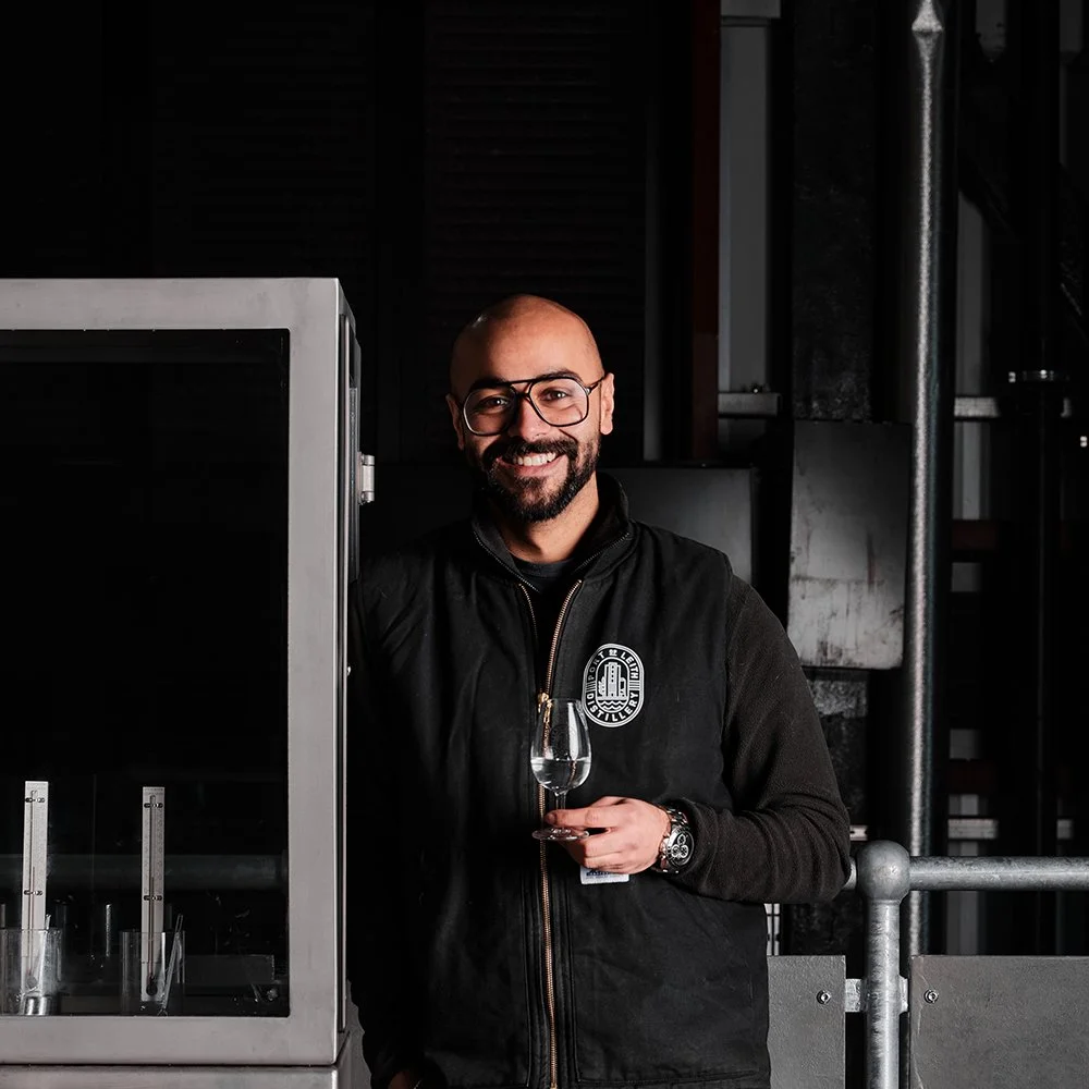 Distiller Vaibhav next to our spirit safe