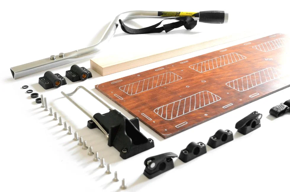 Drawbar, base plate, axle mounts, drawbar mount, and screws laid out on the floor in a photo