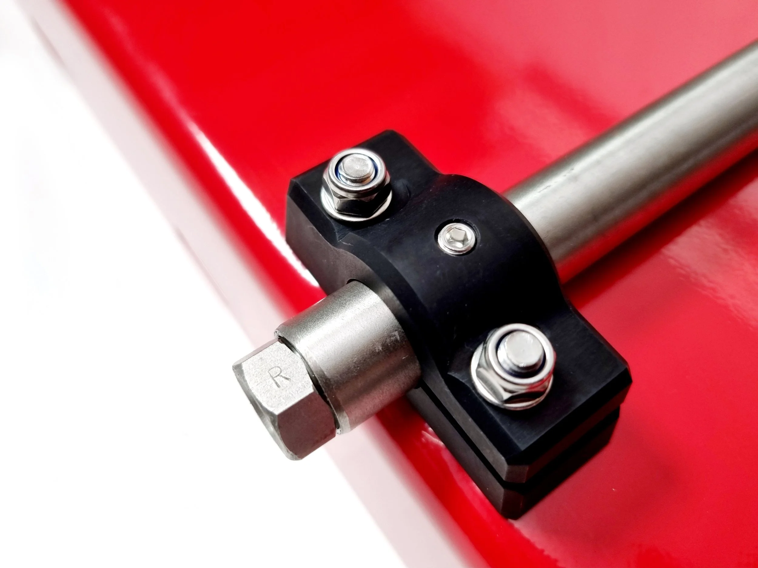 A stainless steel axle for a bicycle trailer, designed for snapping the wheels into place and featuring single-sided mounting