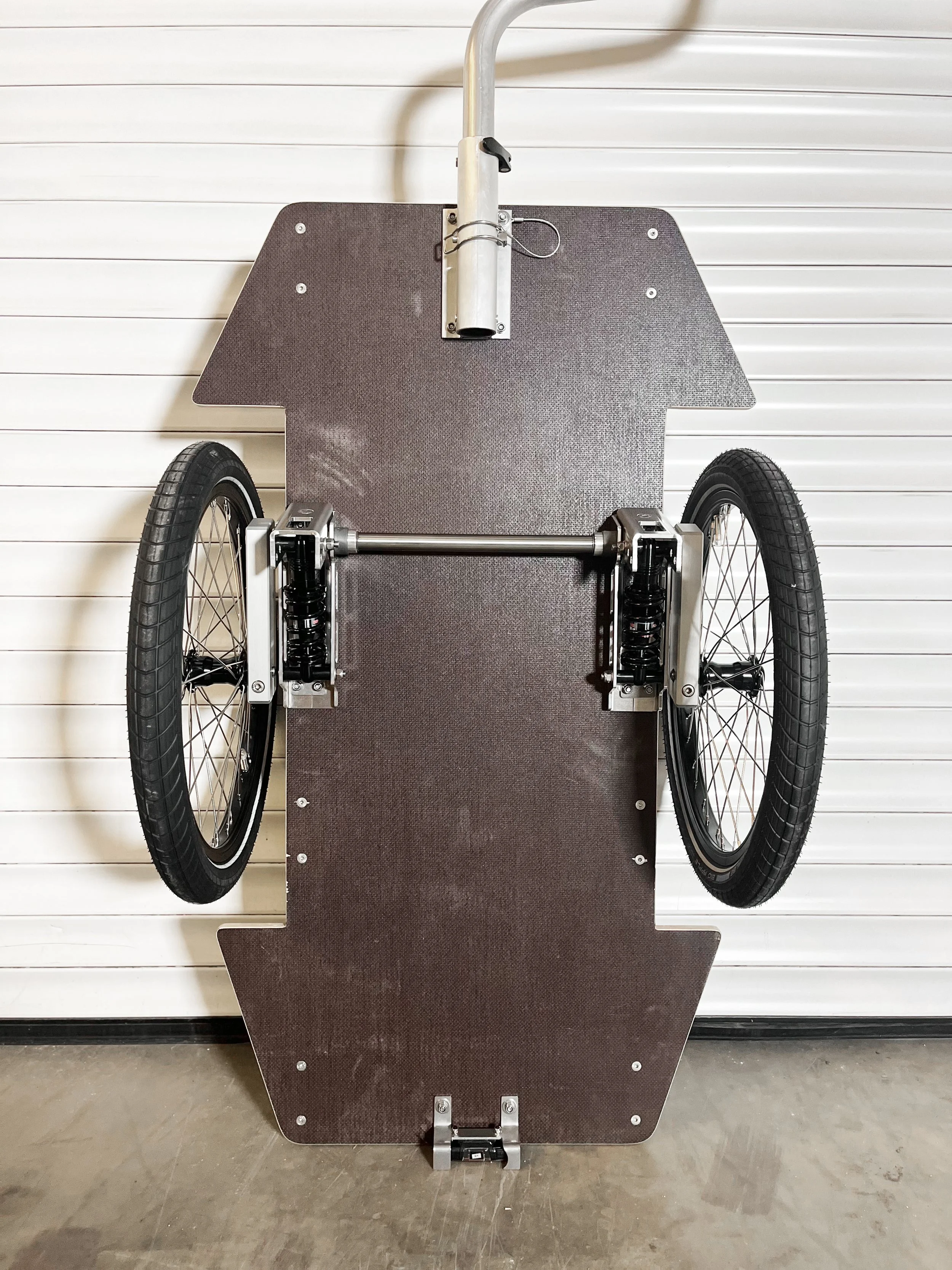 A homemade bicycle trailer with a suspension system featuring hydraulic damping for transporting a musical instrument