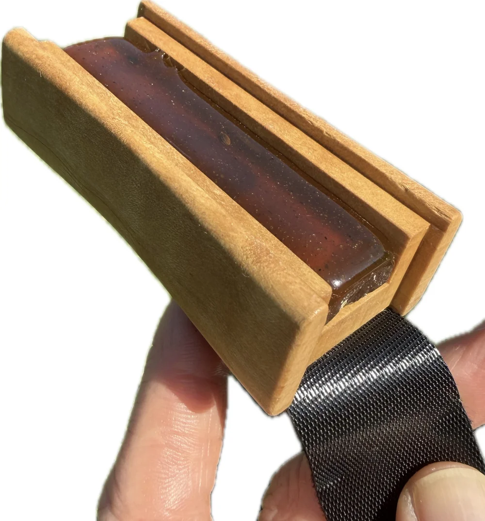 Applying rosin to bow hair