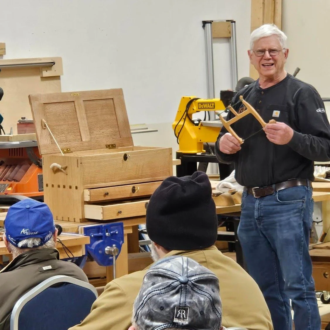 Every meeting we have time for our members to show projects they have been working on and talk about them. That toolbox on the bench is a thing of beauty and the finish on it is amazing. Greg also built the saw he is holding. #woodworking #toolbox