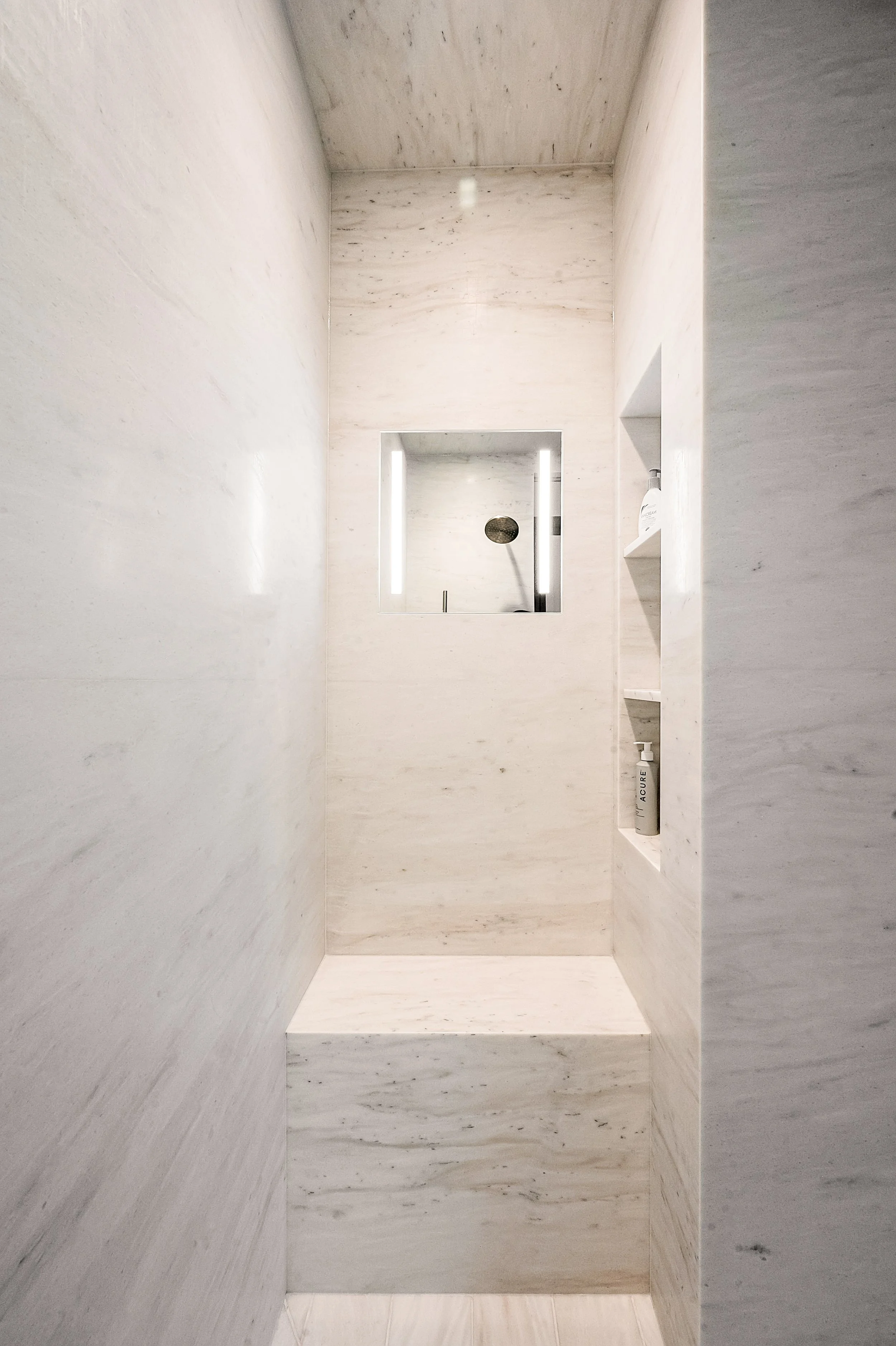 Marble shower detail showing natural stone veining and texture