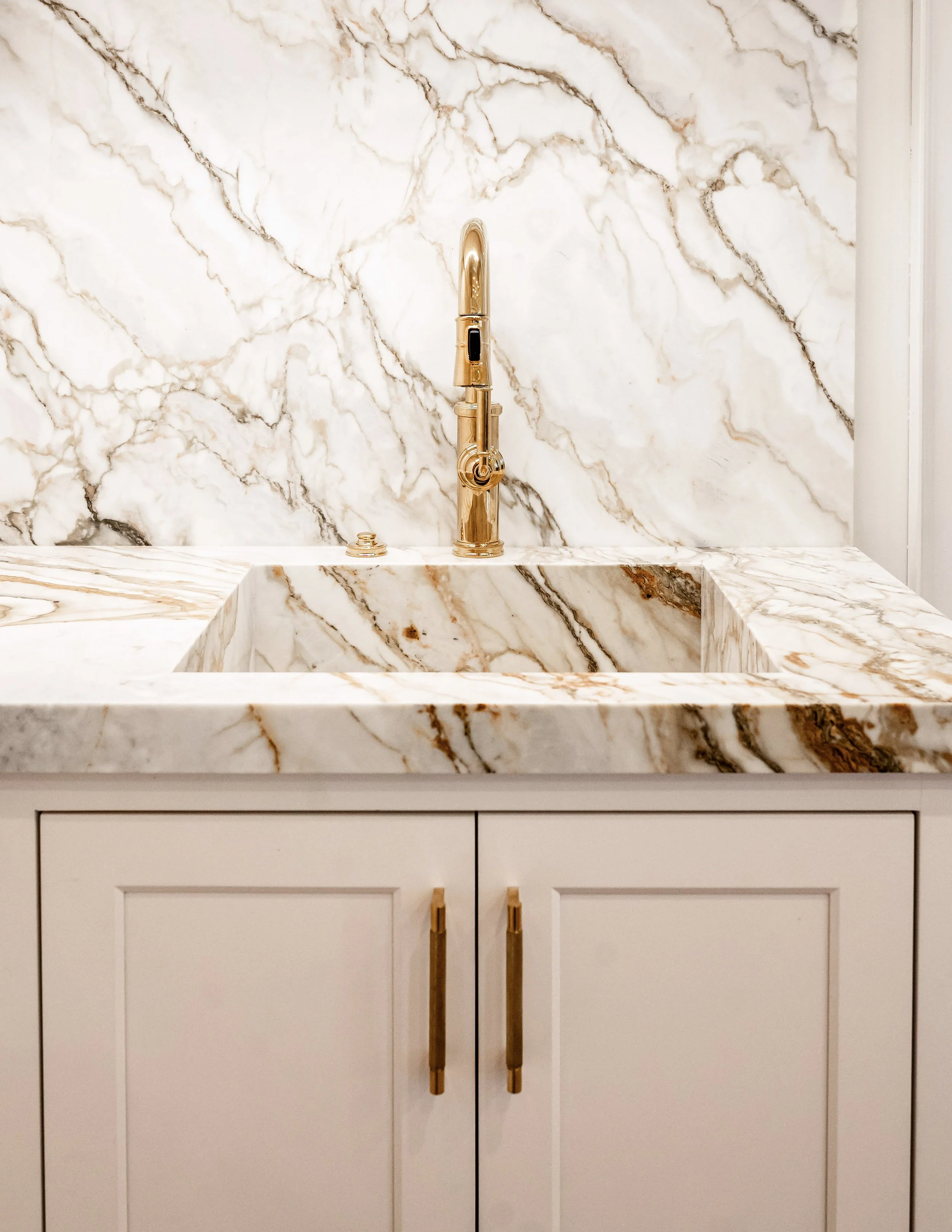 Rio Grande marble countertop with integrated sink and gold fixtures