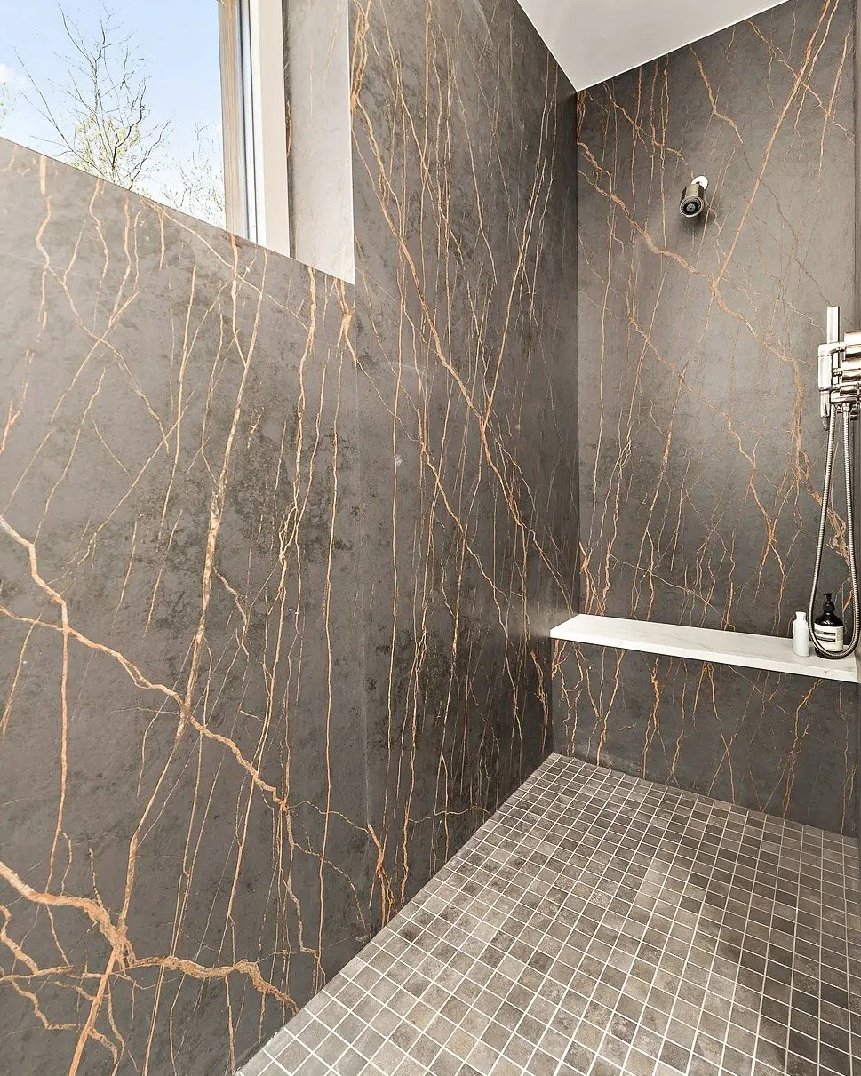Dekton Keyla shower with marble look veining and warm bathroom design