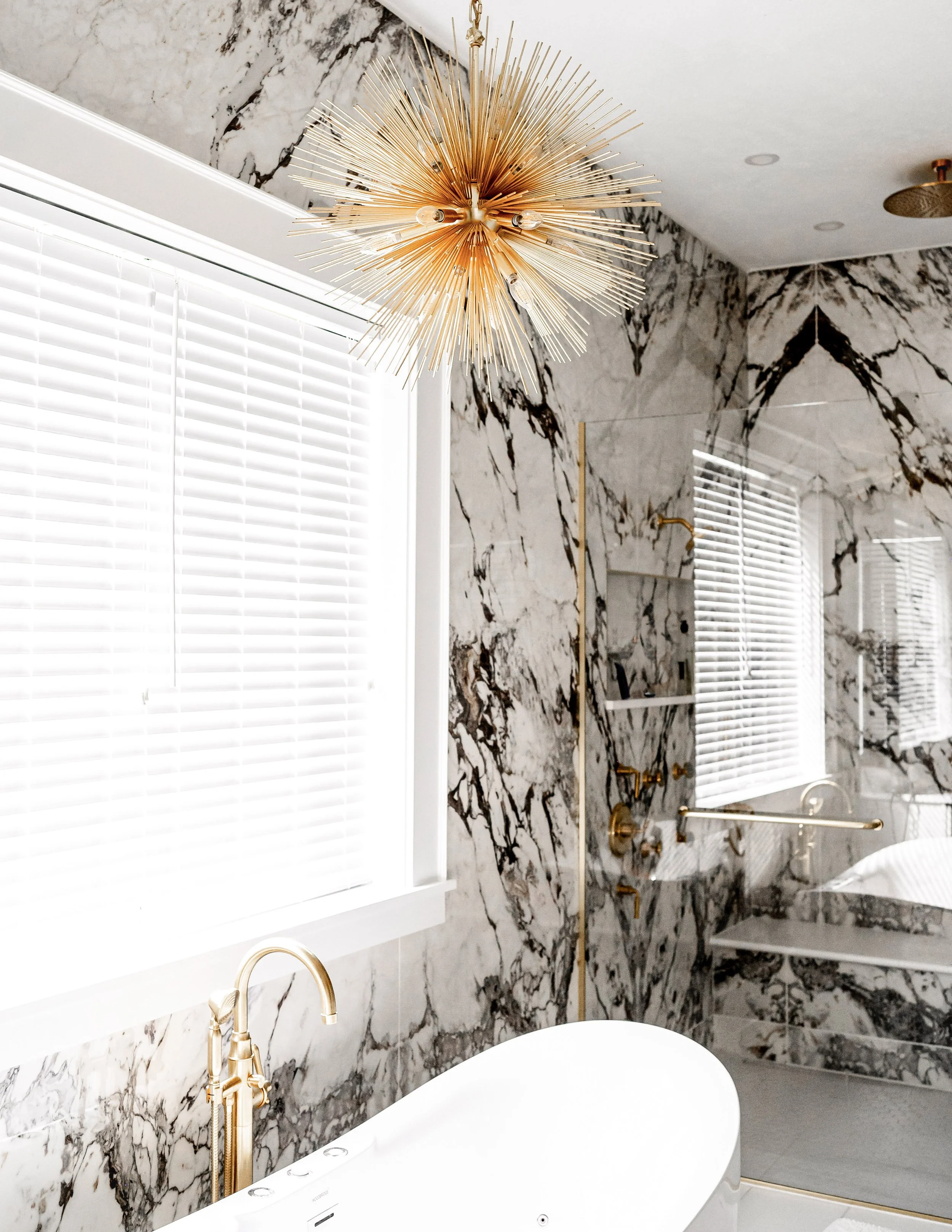 Calacatta Viola look porcelain shower with bold veining and warm bathroom design