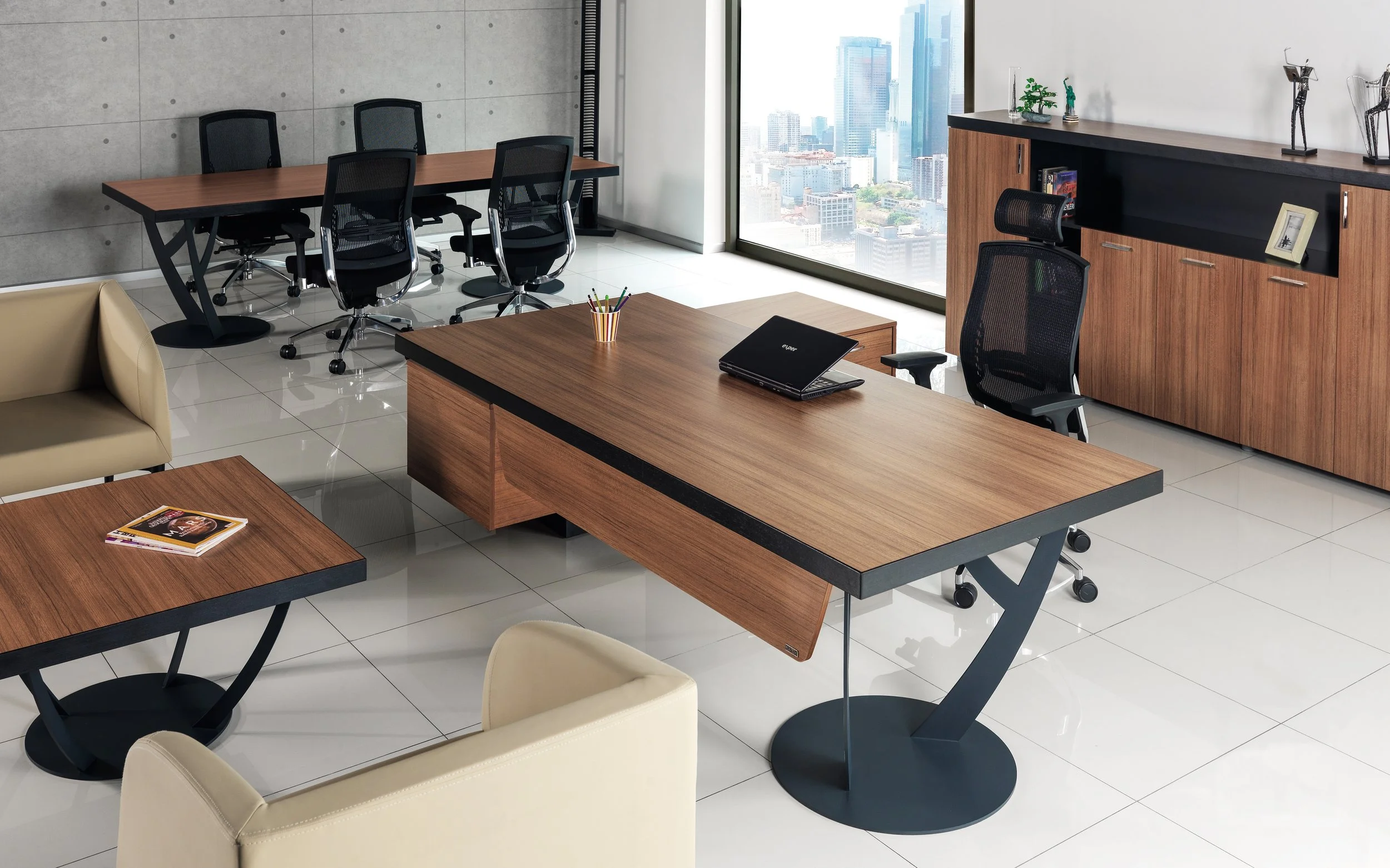 Modern office with a wooden desk, beige chairs, a black office chair, a coffee table with magazines, a sideboard, and a view of a city skyline through large windows.