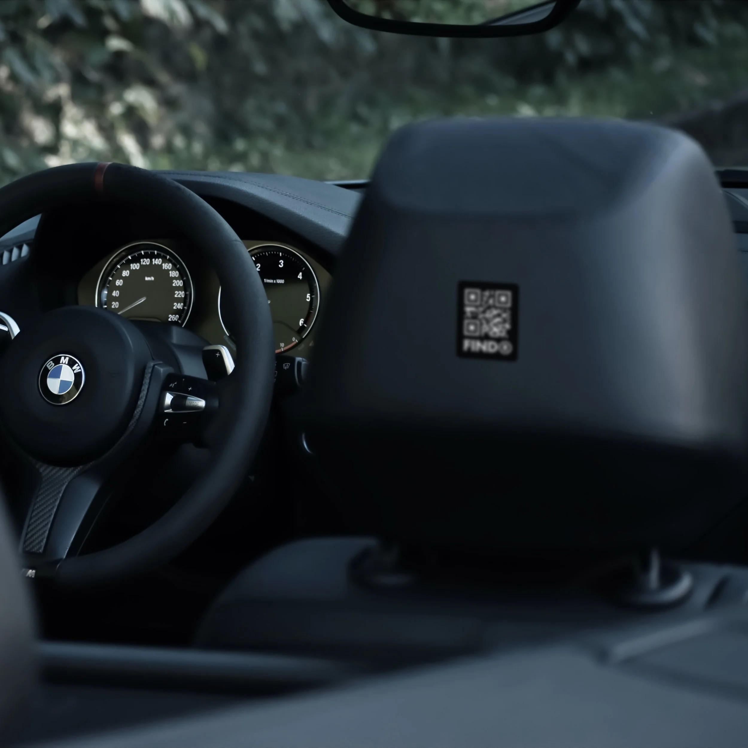FindR QR code sticker on a car headrest