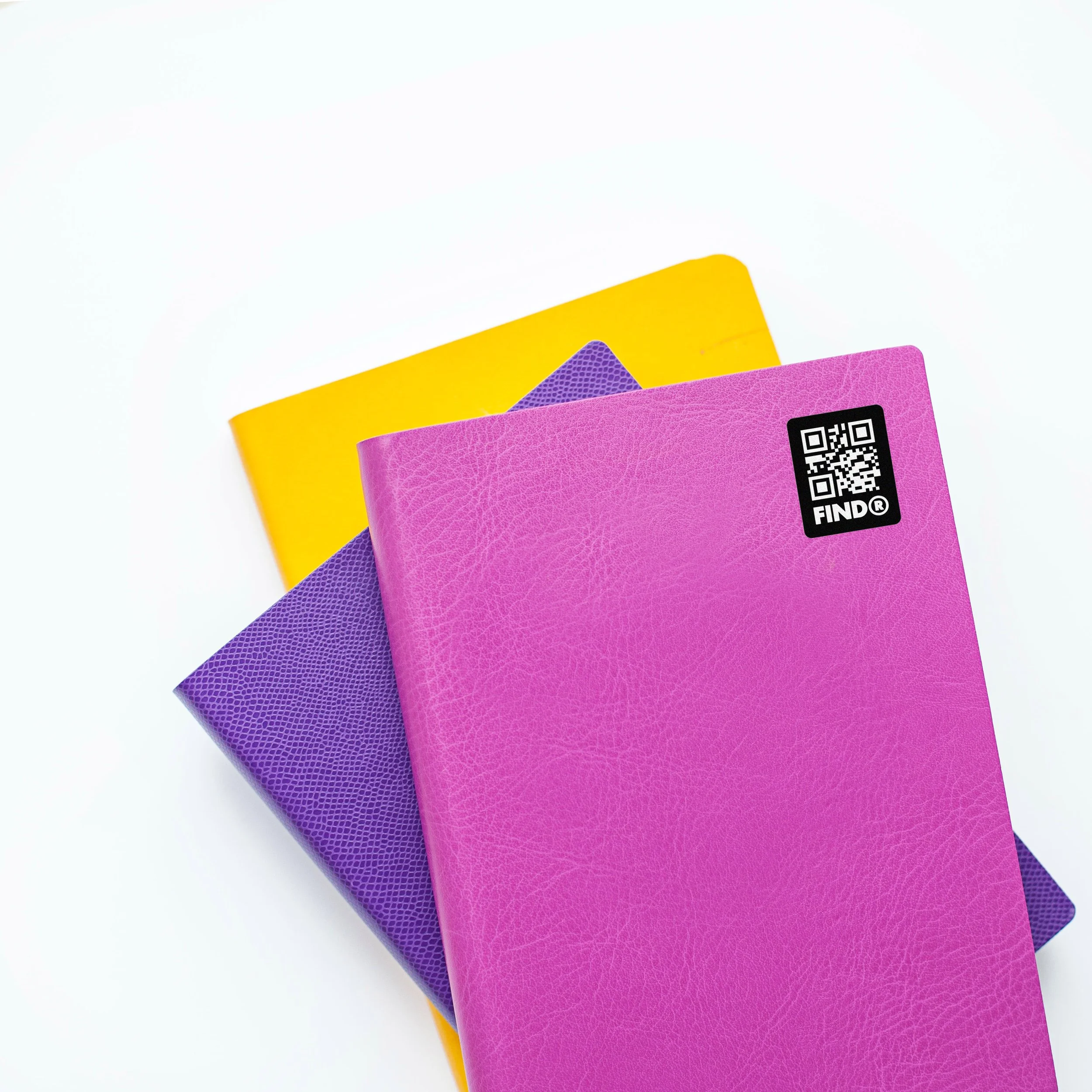 FindR QR code sticker on a colorful notebook