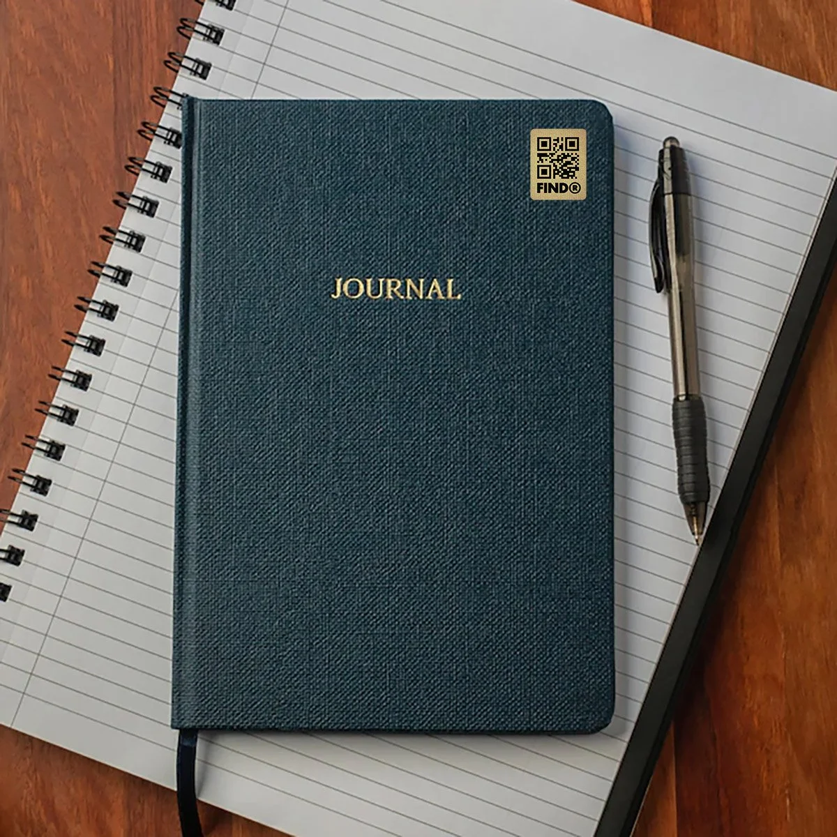 FindR QR code sticker on a notebook