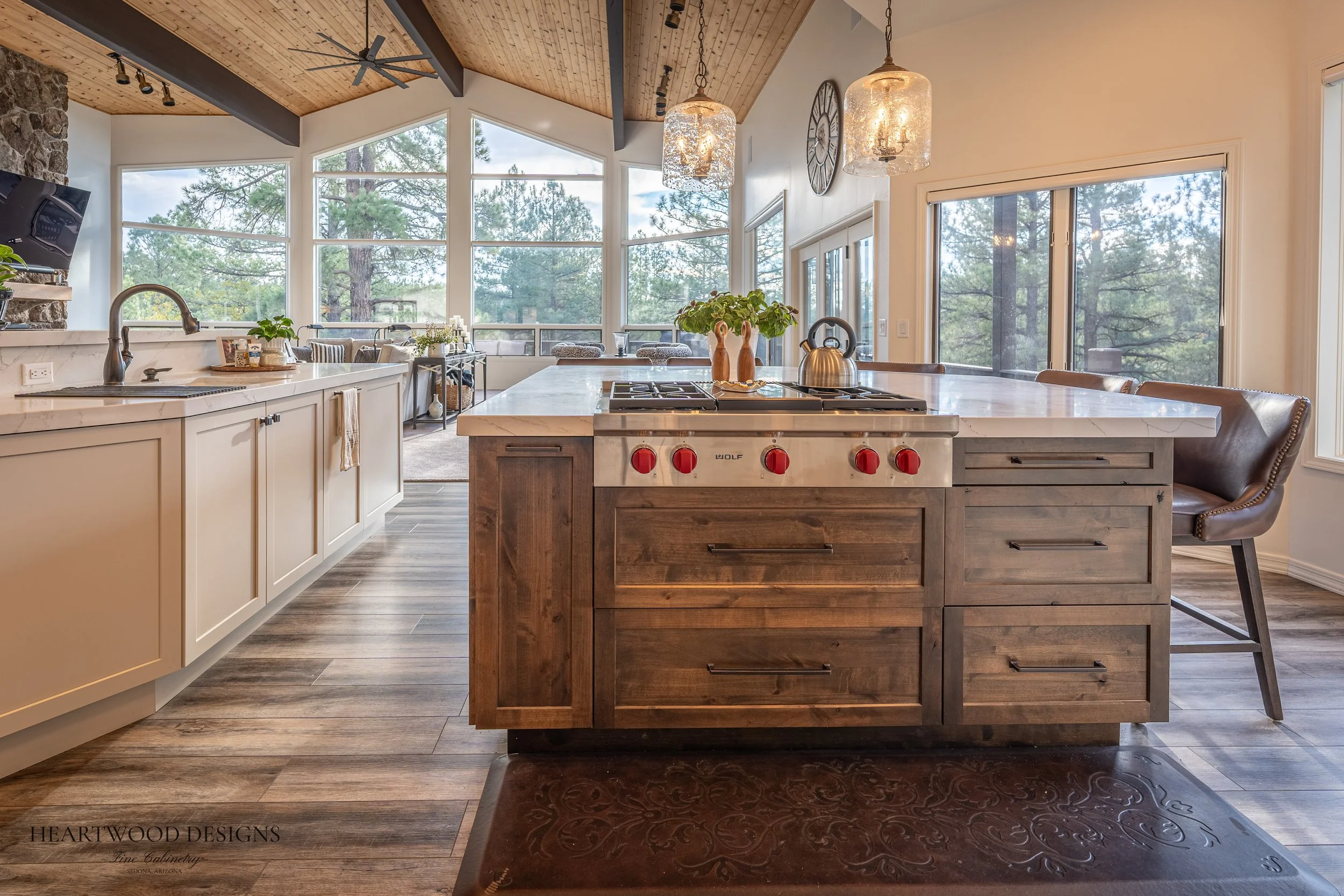 Dark stained knotty alder kitchen island with white painted shaker cabinets in Forest Highlands, Flagstaff AZ