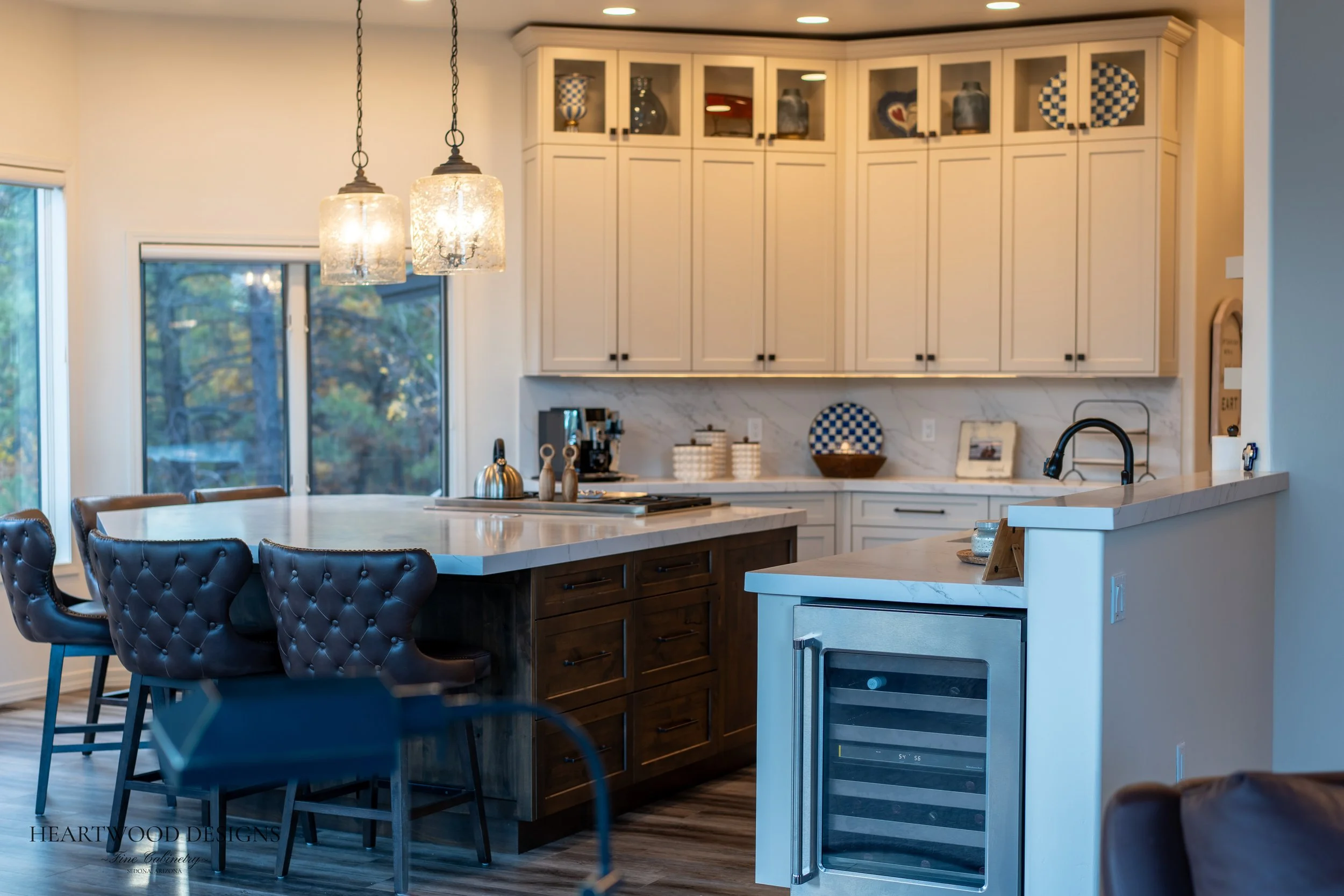 Dark stained knotty alder kitchen island with white painted shaker cabinets in Forest Highlands, Flagstaff AZ
