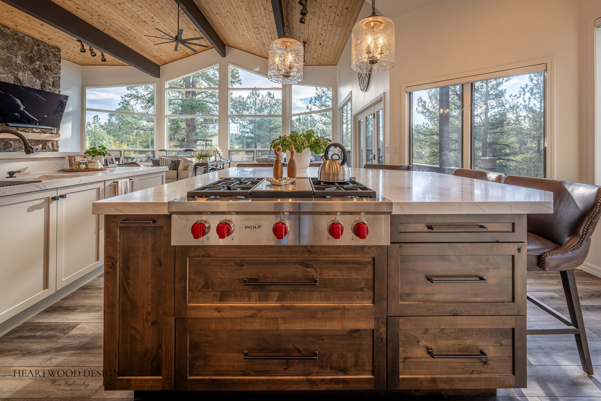 Dark stained knotty alder kitchen island with white painted shaker cabinets in Forest Highlands, Flagstaff AZ
