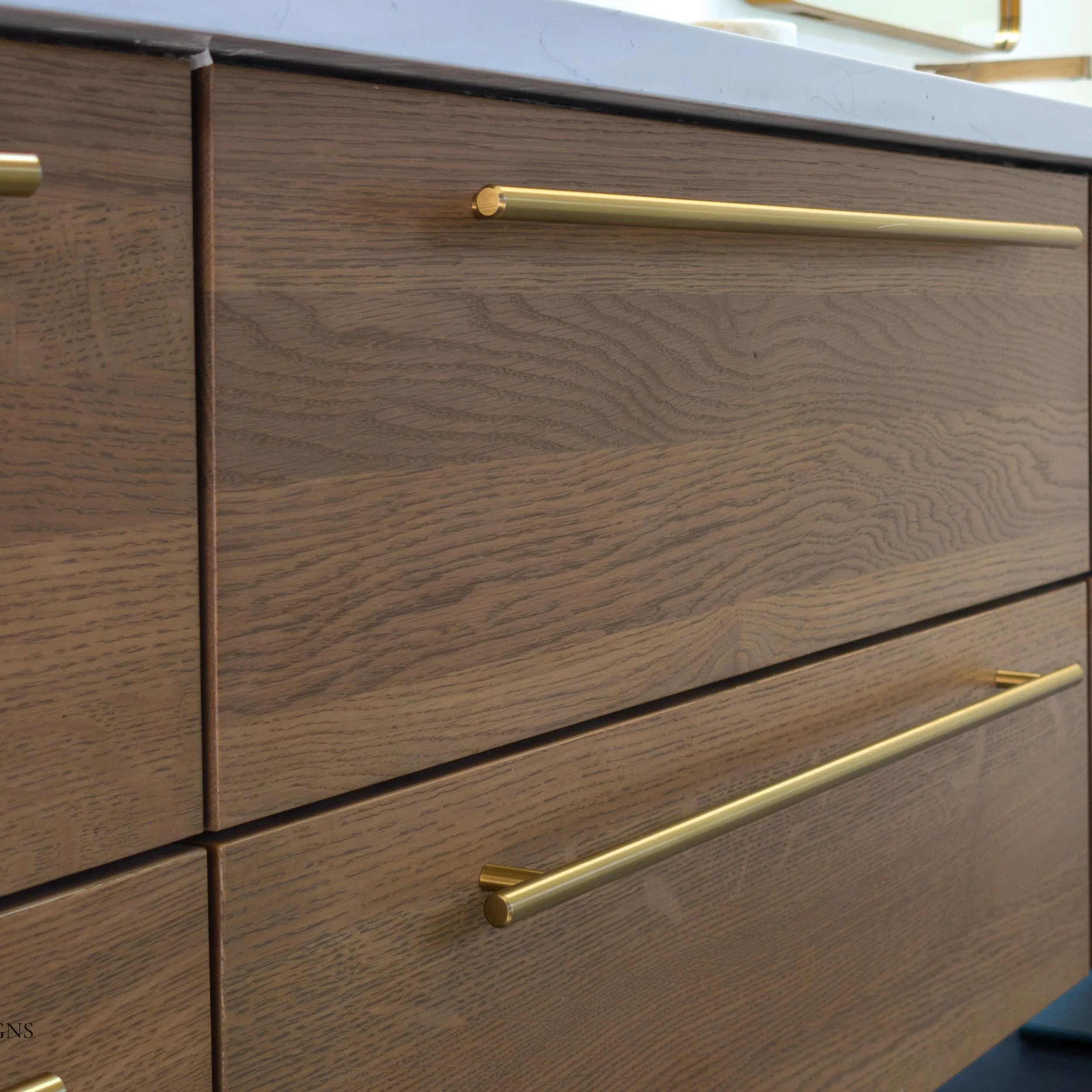 Modern bathroom floating vanity in Quarter Sawn White Oak with rich brown stain and bar pulls