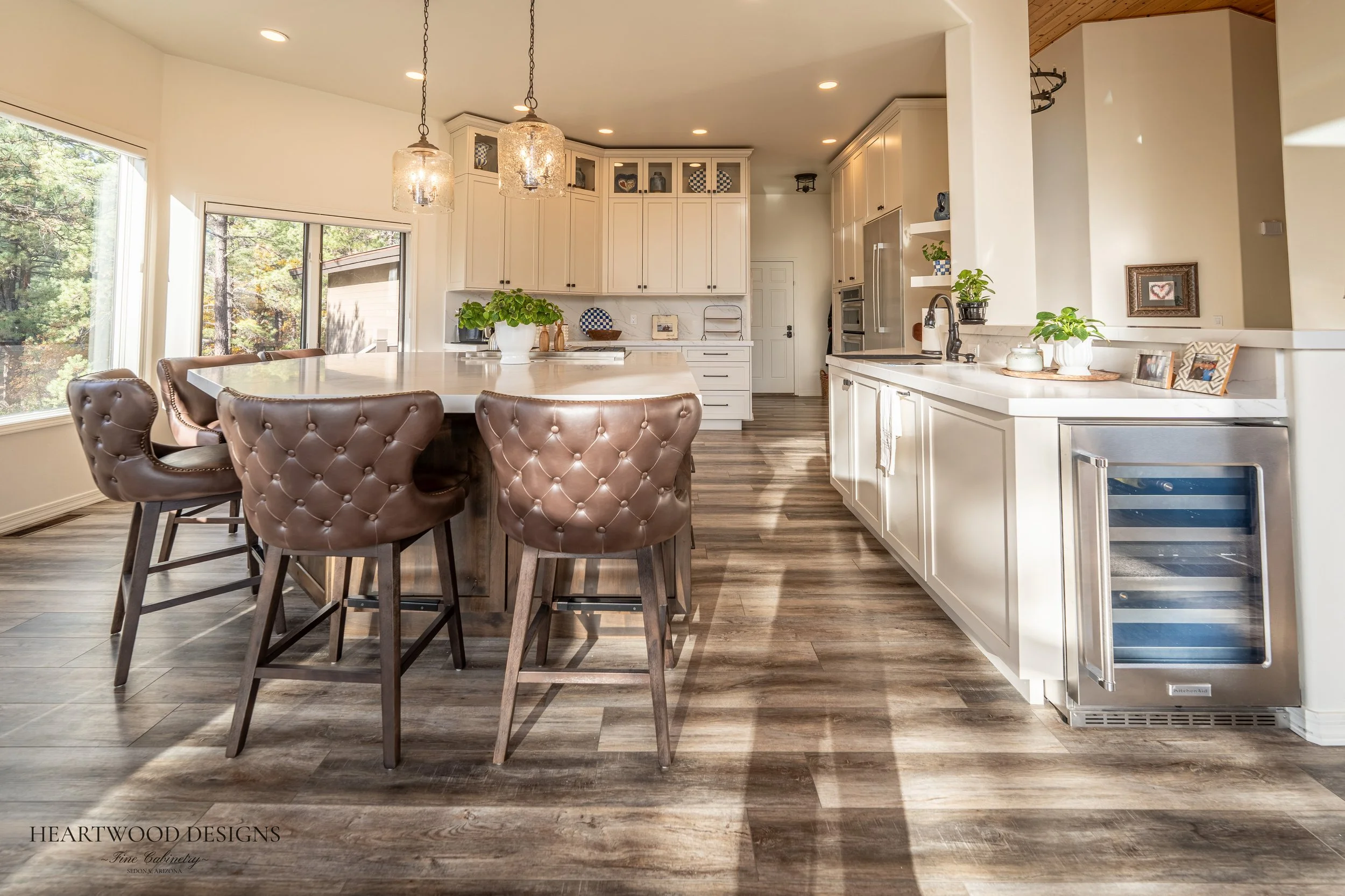 Dark stained knotty alder kitchen island with white painted shaker cabinets in Forest Highlands, Flagstaff AZ