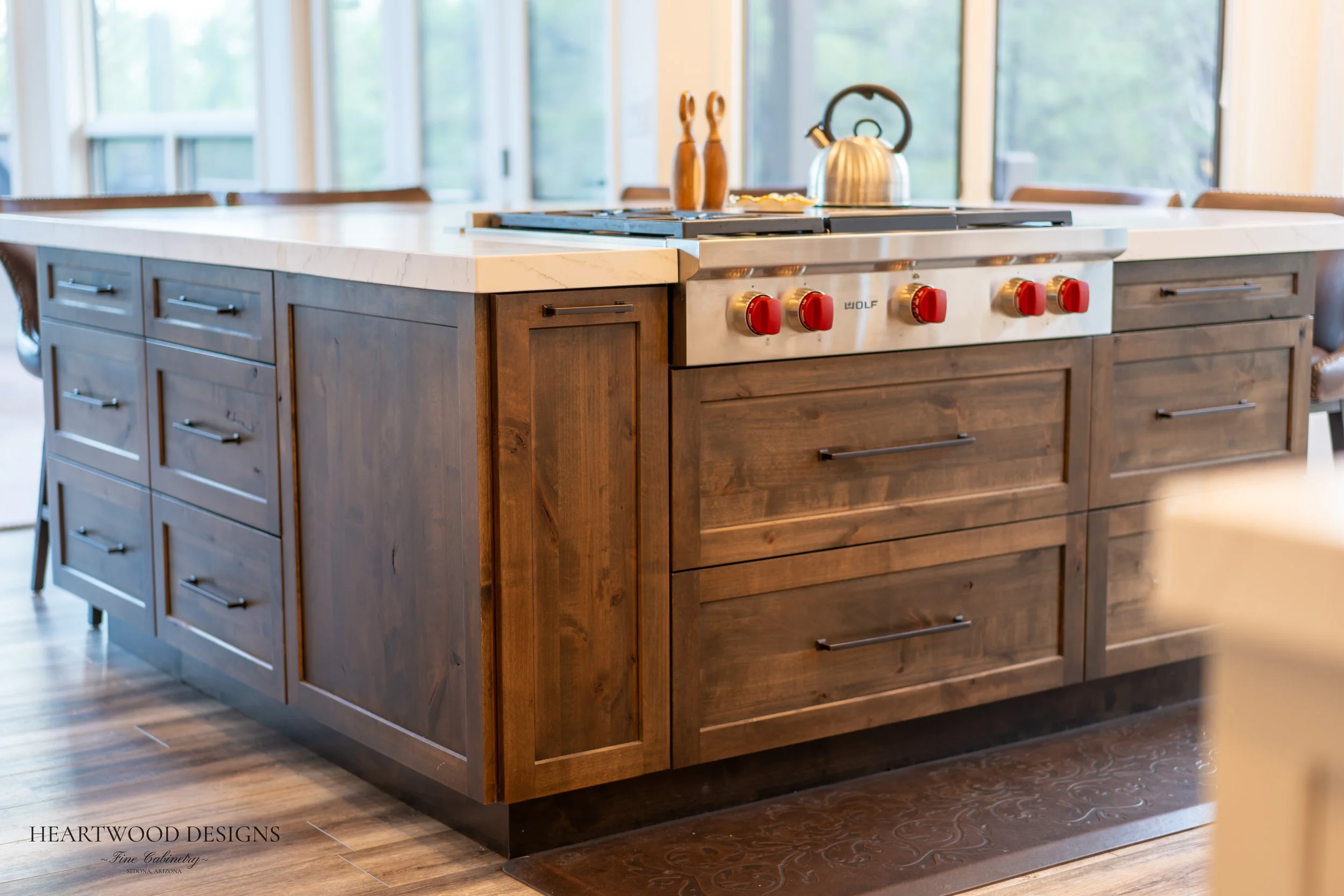 Dark stained knotty alder kitchen island with white painted shaker cabinets in Forest Highlands, Flagstaff AZ