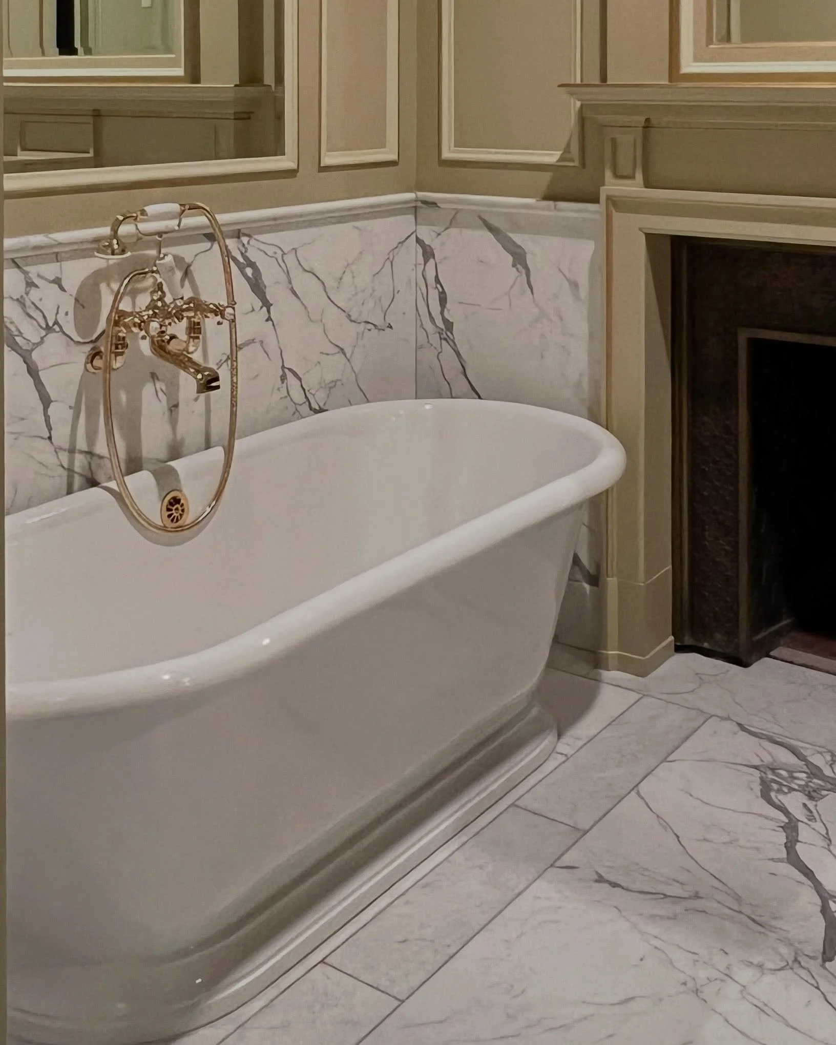 Oh, but this bath&hellip;

Designed around the existing bronze-lined firebox, I detailed this new mantle and vanity with hints of Louis XVI.  Upper wood and mirror panels flow seamlessly with the marbled wainscoting and floors.  Light fixtures to fol