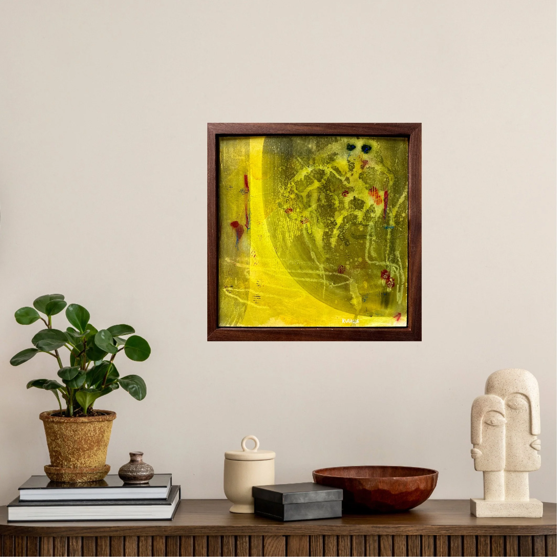 A modern still life arrangement on a wooden sideboard with decorative objects, a potted plant, and an abstract painting on a beige wall.