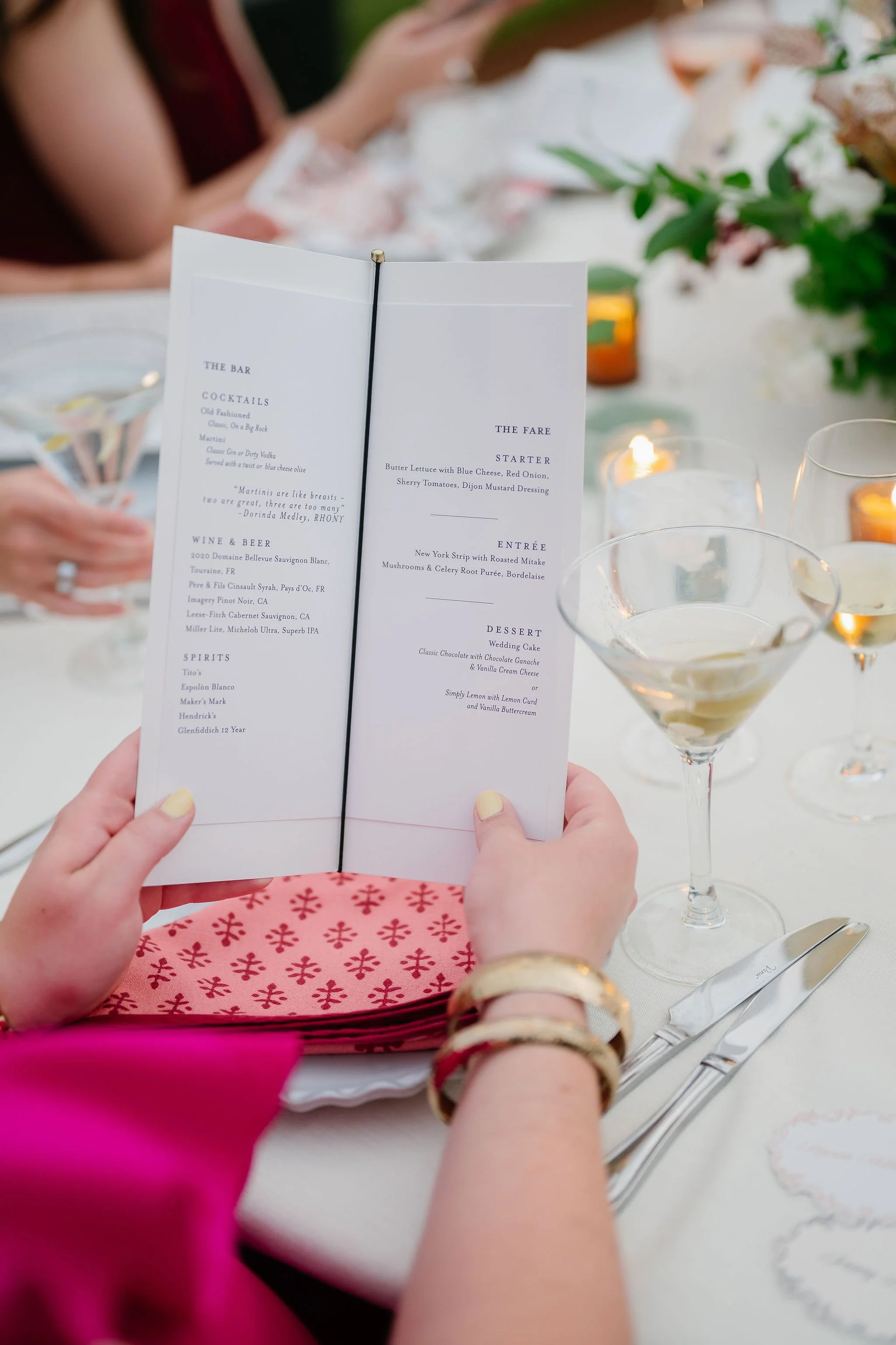 Wedding guest holding open personalized dinner menu at the Clifton Inn
