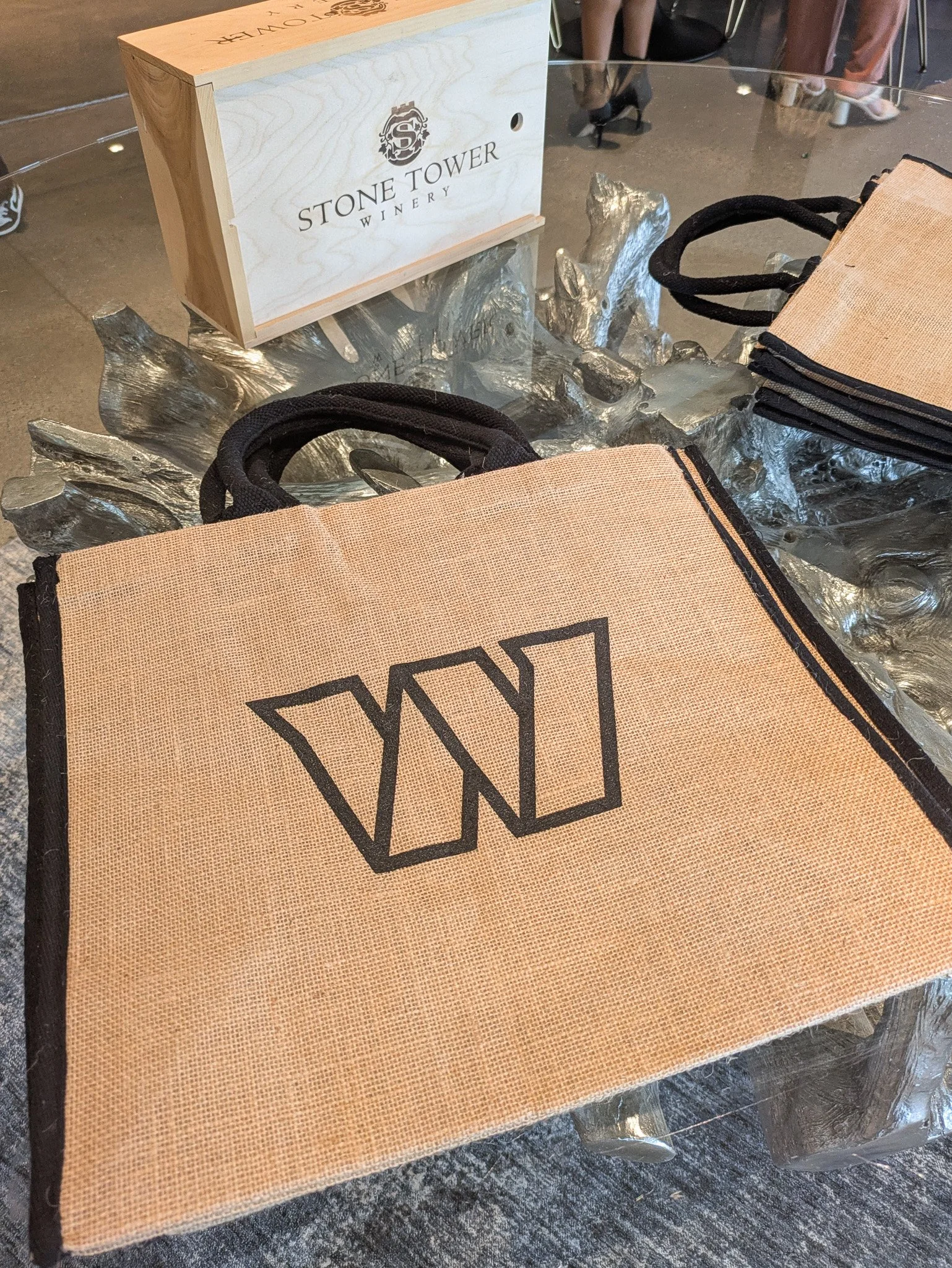 Stone Tower Winery branded gifting display with Washington Commanders tote bags