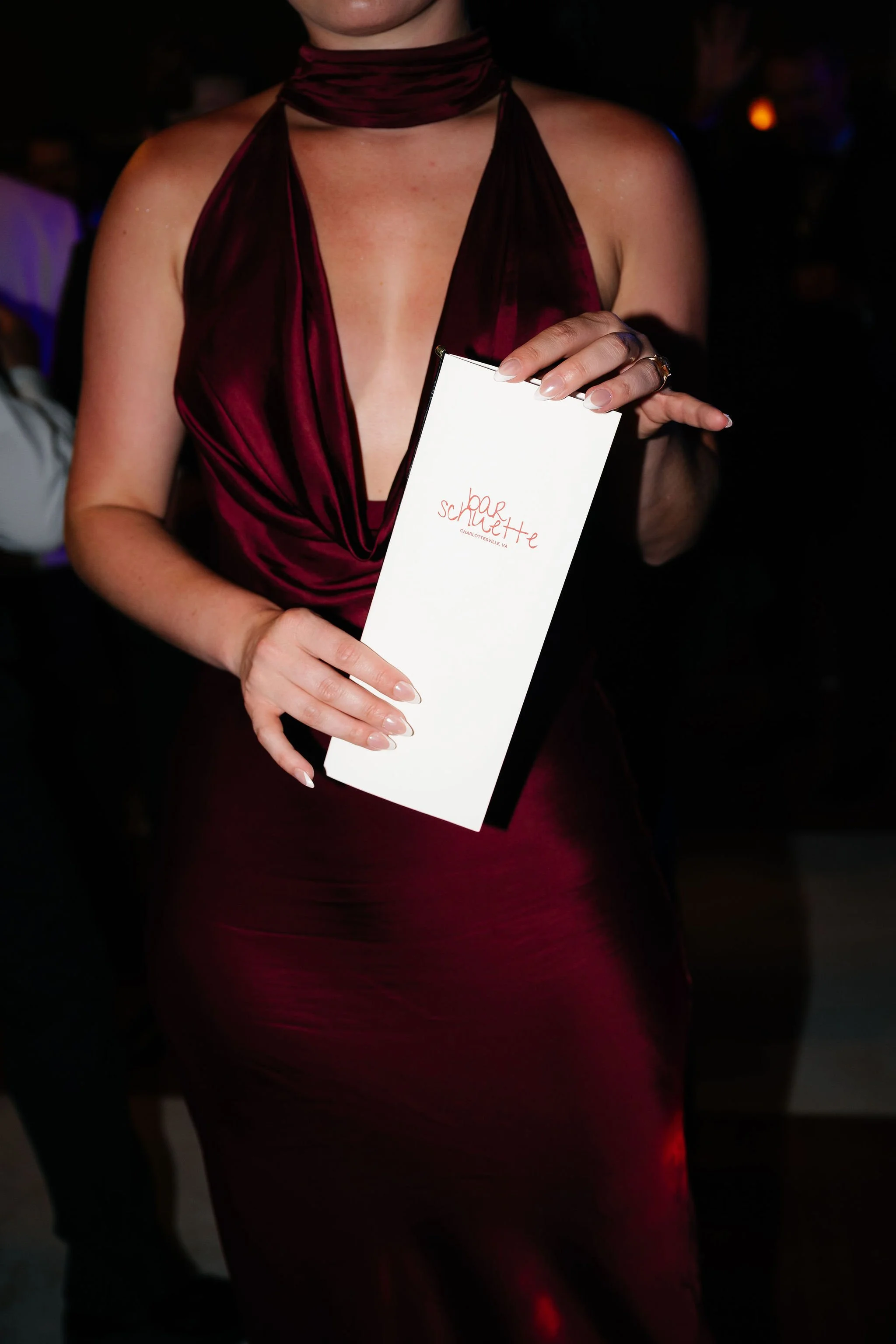 Wedding guest holding custom personalized dinner menu at Charlottesville wedding reception