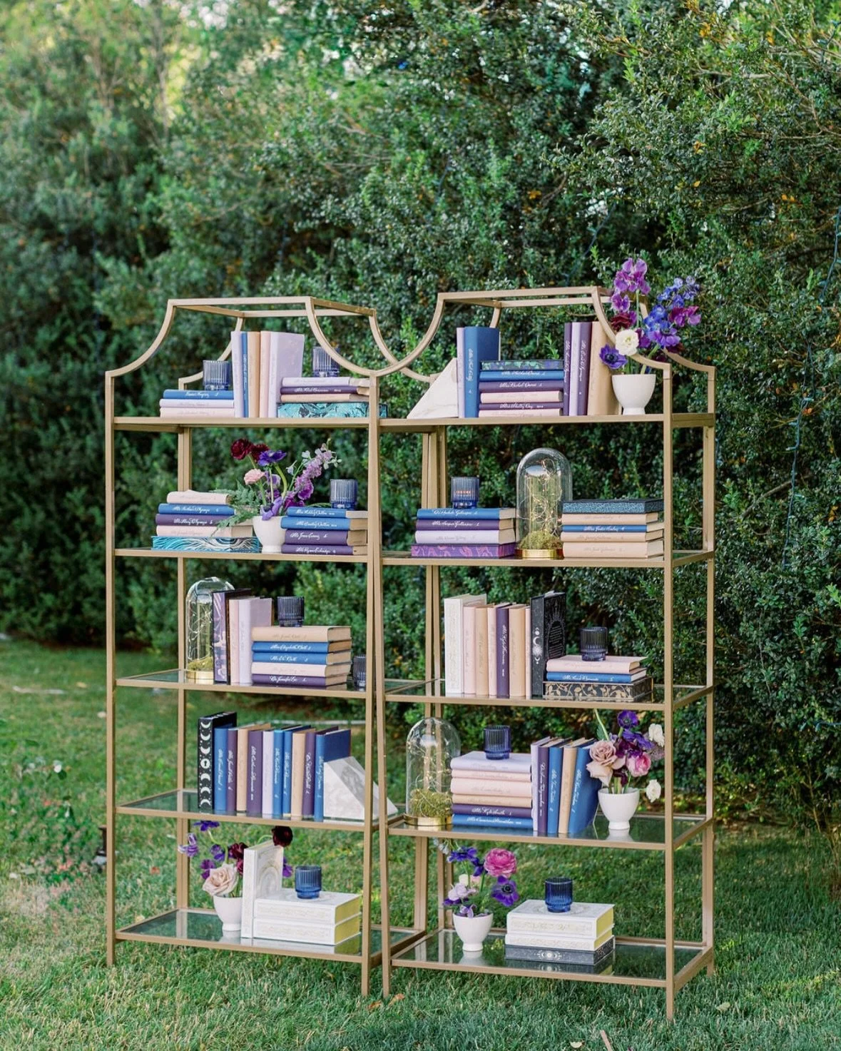 Full bookshelf escort wall with hand-lettered calligraphy seating cards at a private estate wedding in Virginia